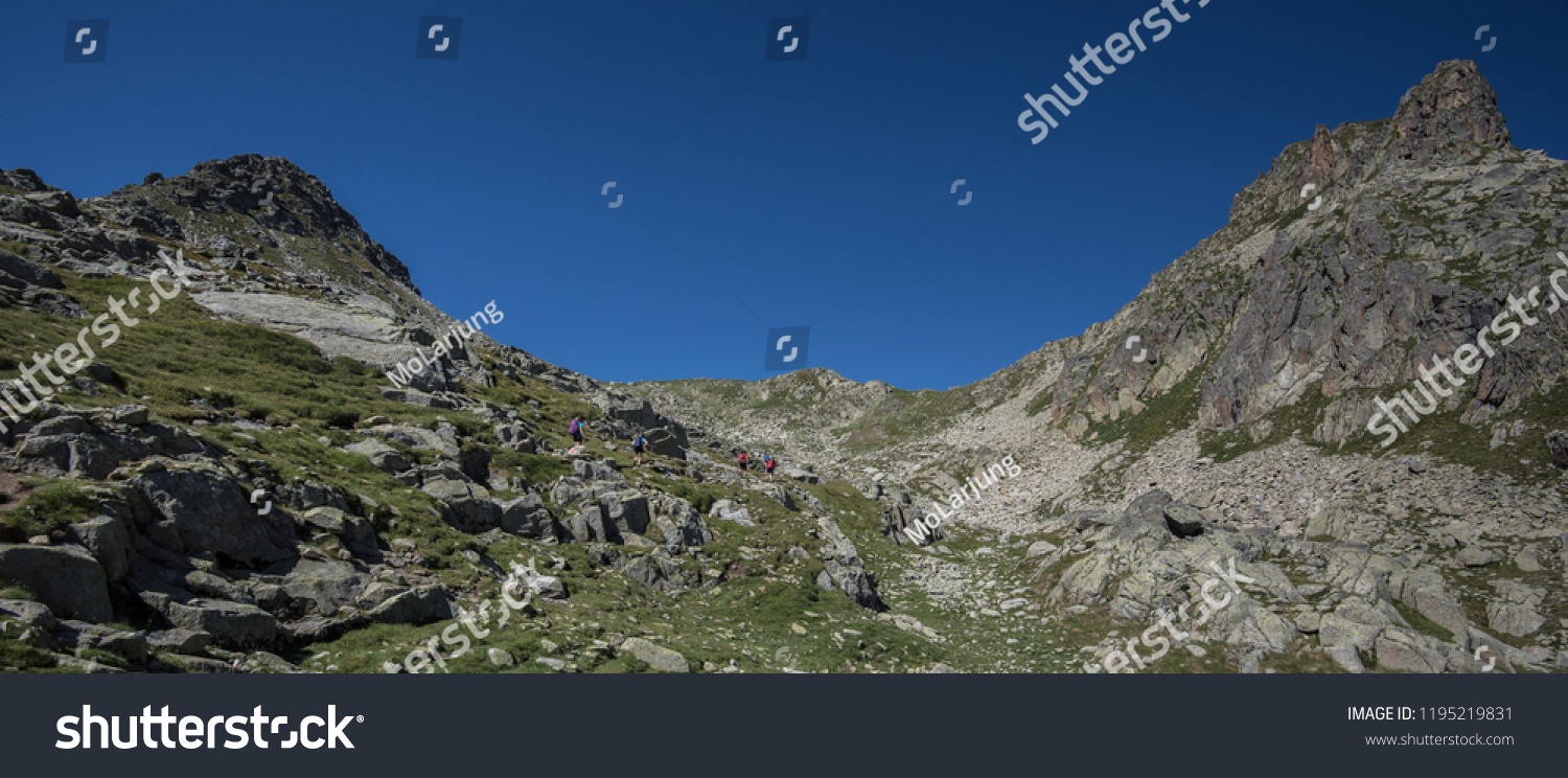 Trekkers on ascent to Port de Caldes de Colomers mountain pass at 2,572 m ASL, Aiguestortes & Estany de Sant Maurici National Park, Pyrenees, Spain #1195219831
