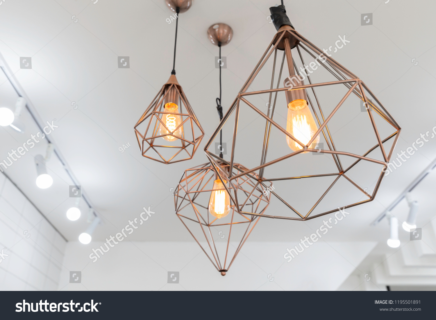 retro copper hanging lamp with orange light bulb. #1195501891