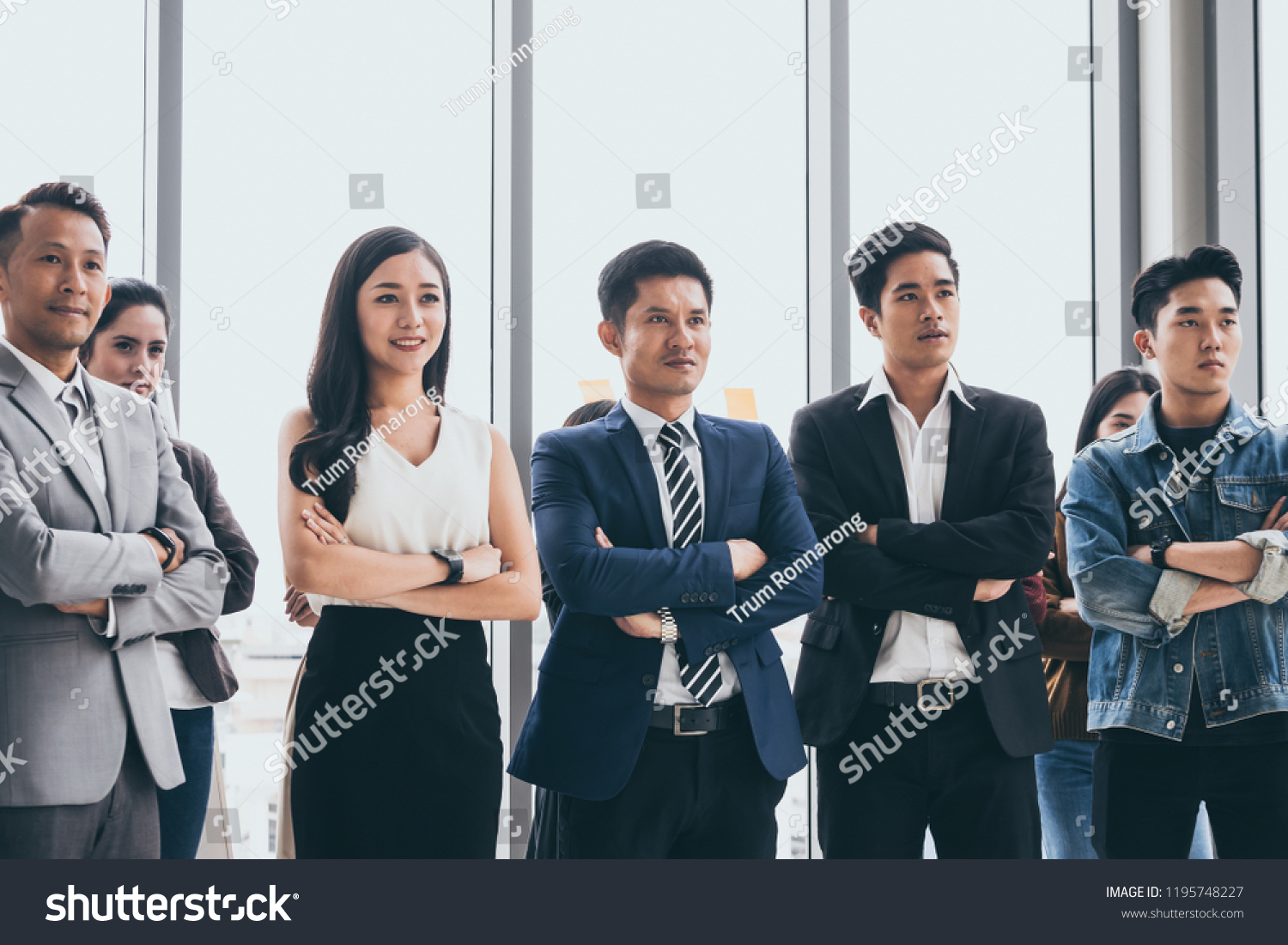 Asian Businesspeople are standing up and smiling at the office. #1195748227