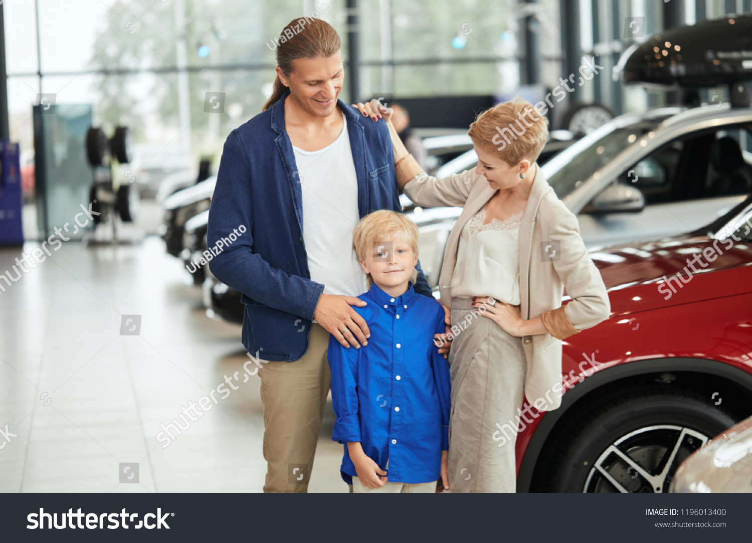 Happy family near new car. Auto dealership centre #1196013400
