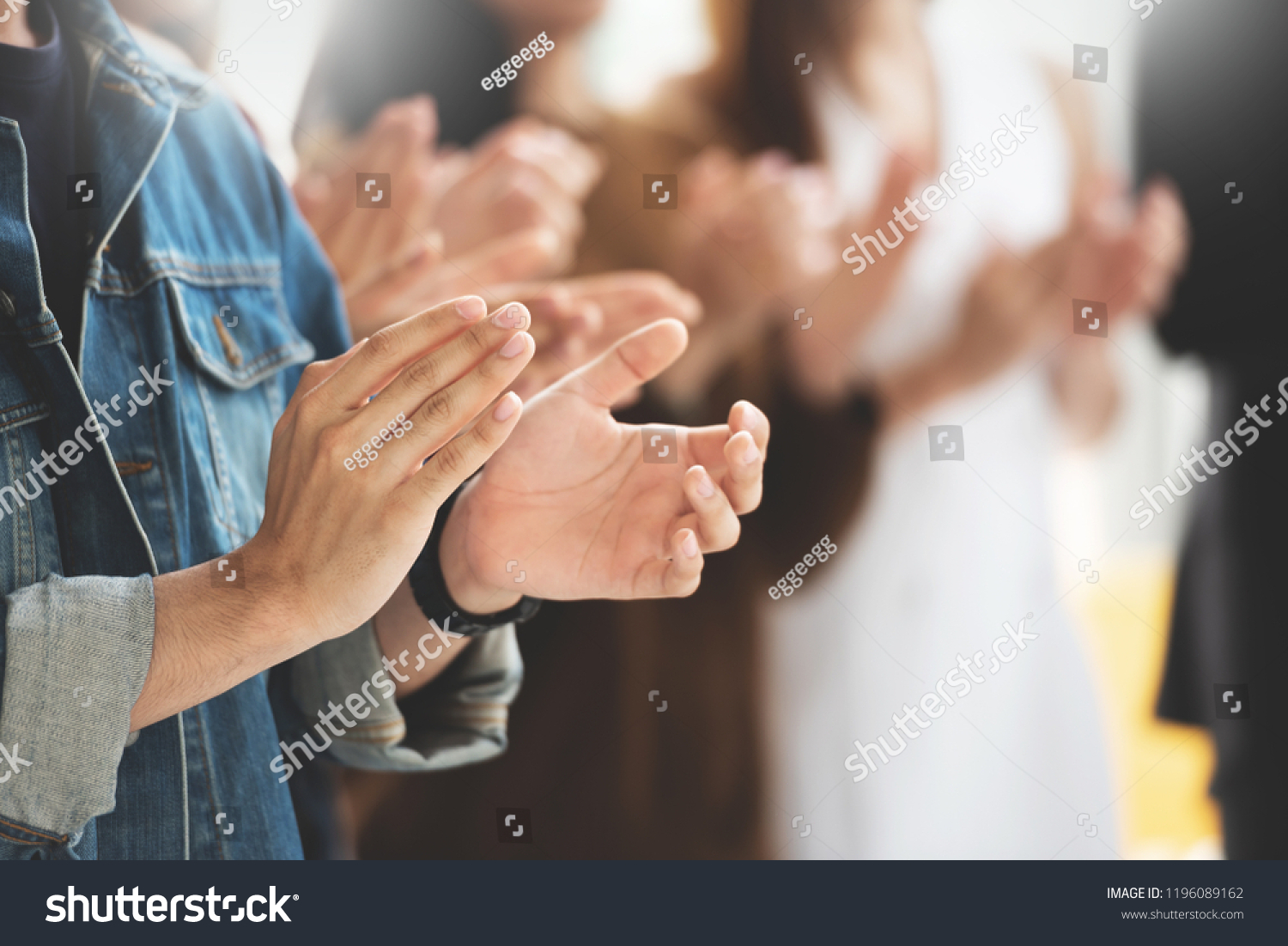 Selective Focus on hands. Creative designers audience applauding at a business seminar. Asian People listening and clapping at conference and presentation. #1196089162