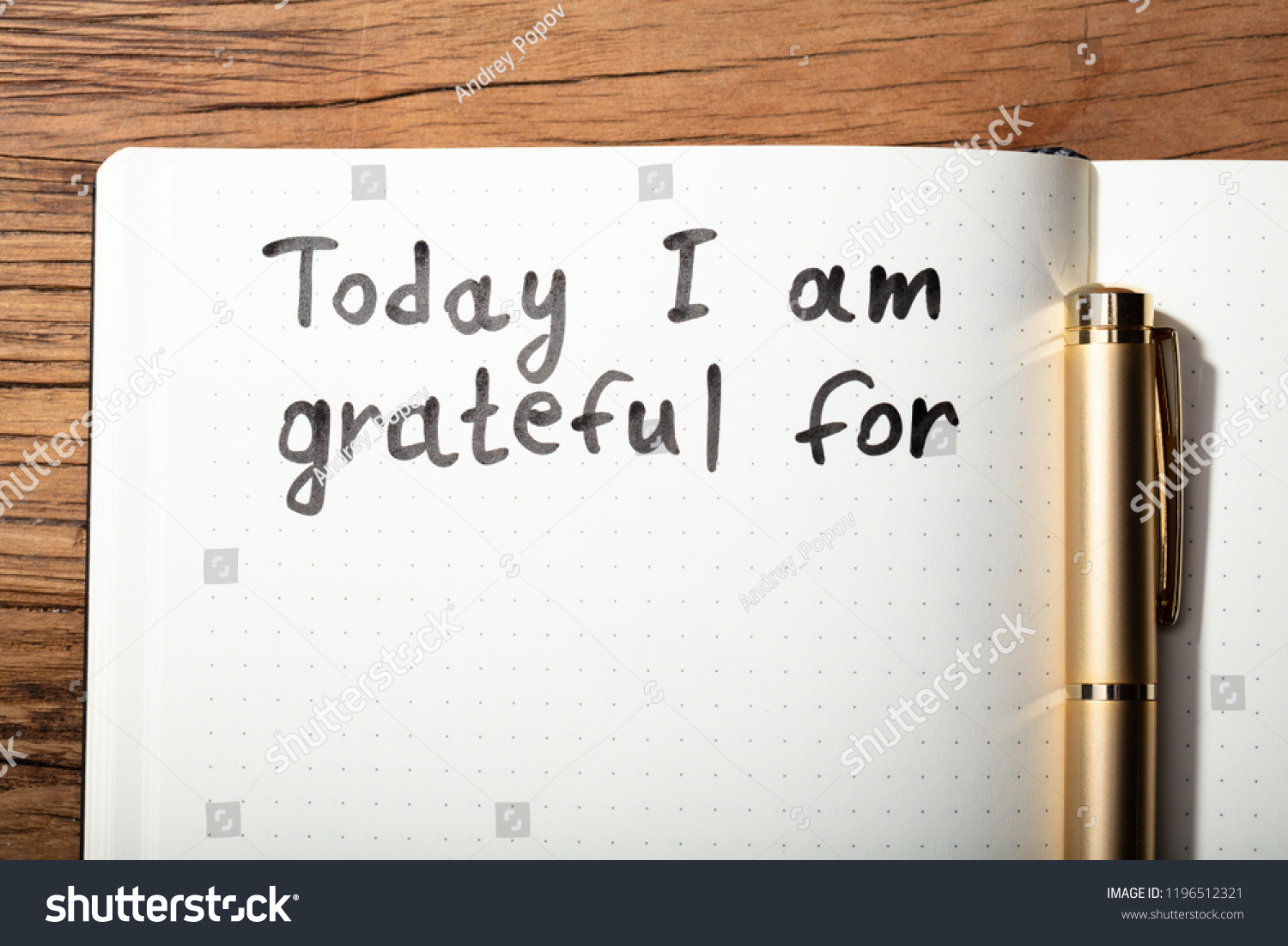 Close-up Of Gratitude Word With Pen On Notebook Over Wooden Desk #1196512321