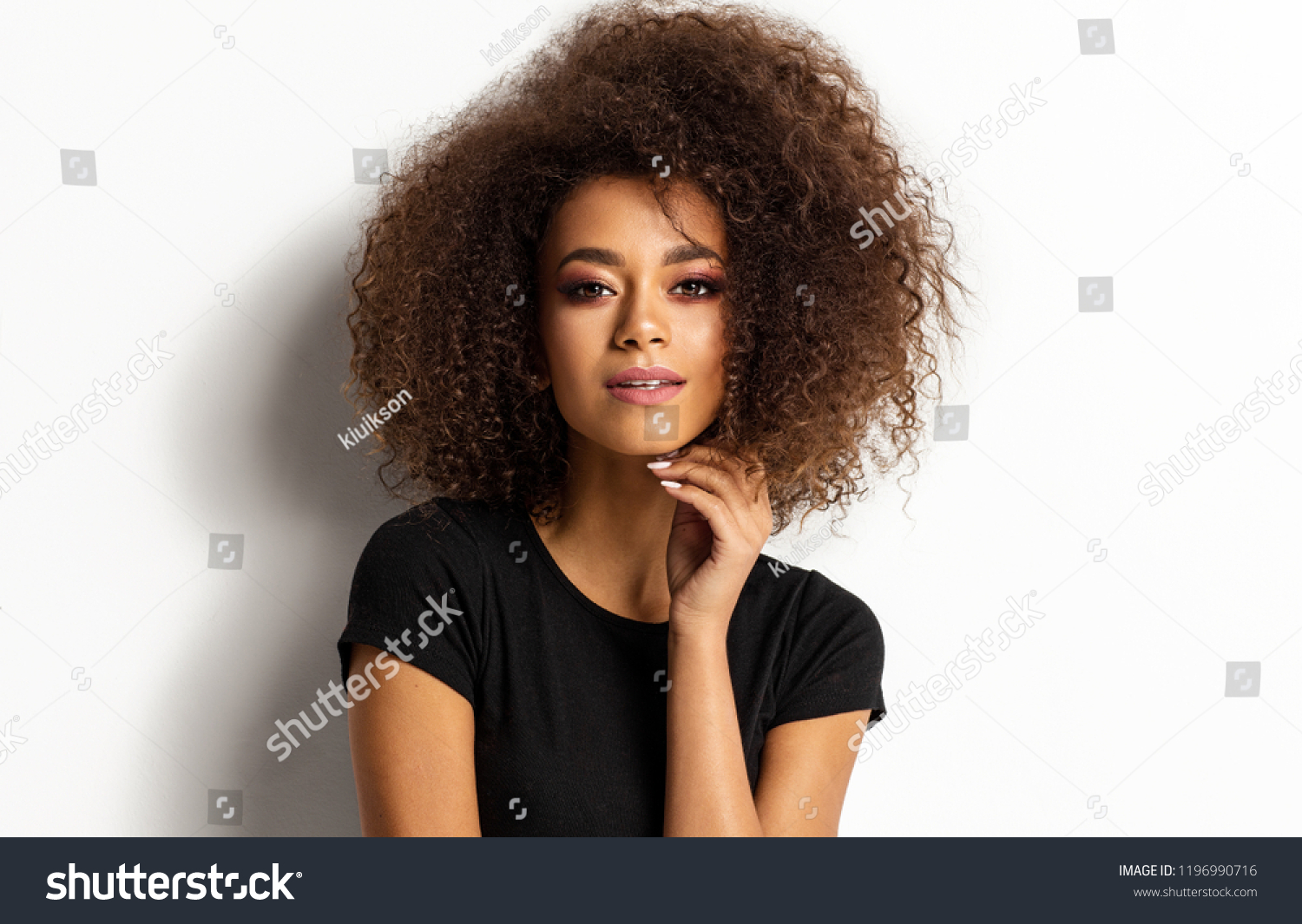 Beauty portrait of young adult african american woman with afro hairstyle looking at camera isolated on white background #1196990716