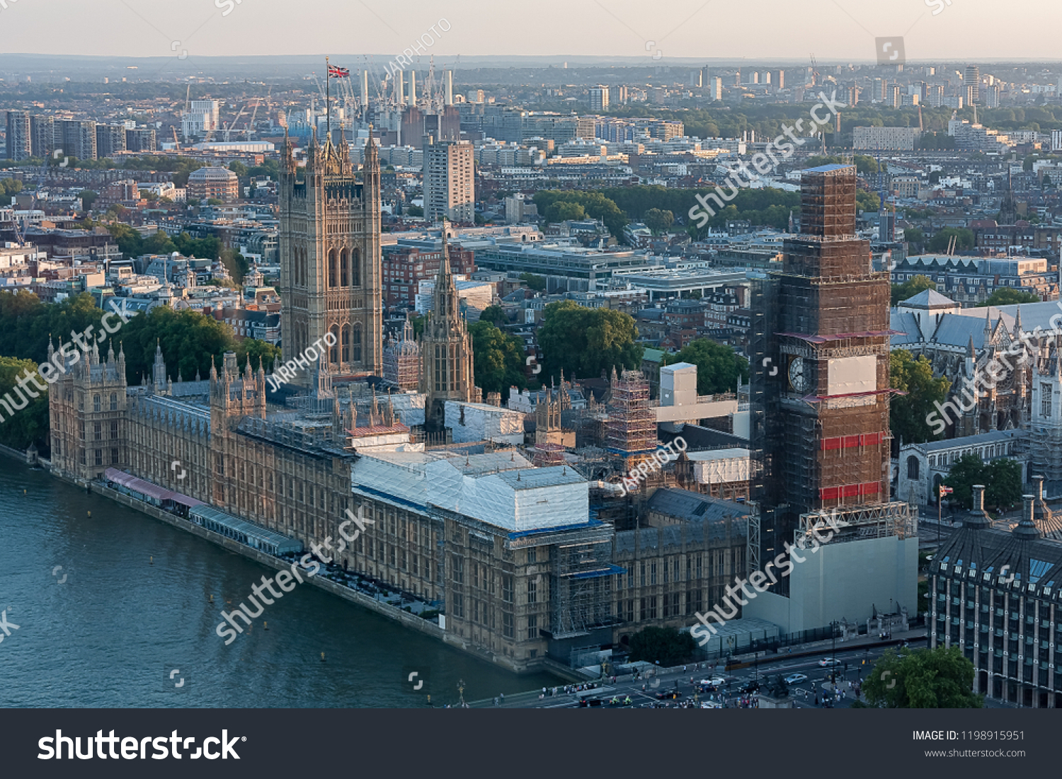 the london parliament with the bigben under construction and general view of the Thames River #1198915951