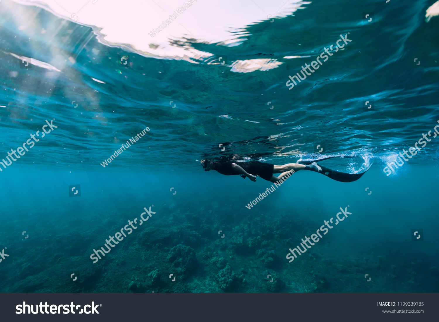 Freediver in wetsuit neoprene swim in the sea #1199339785