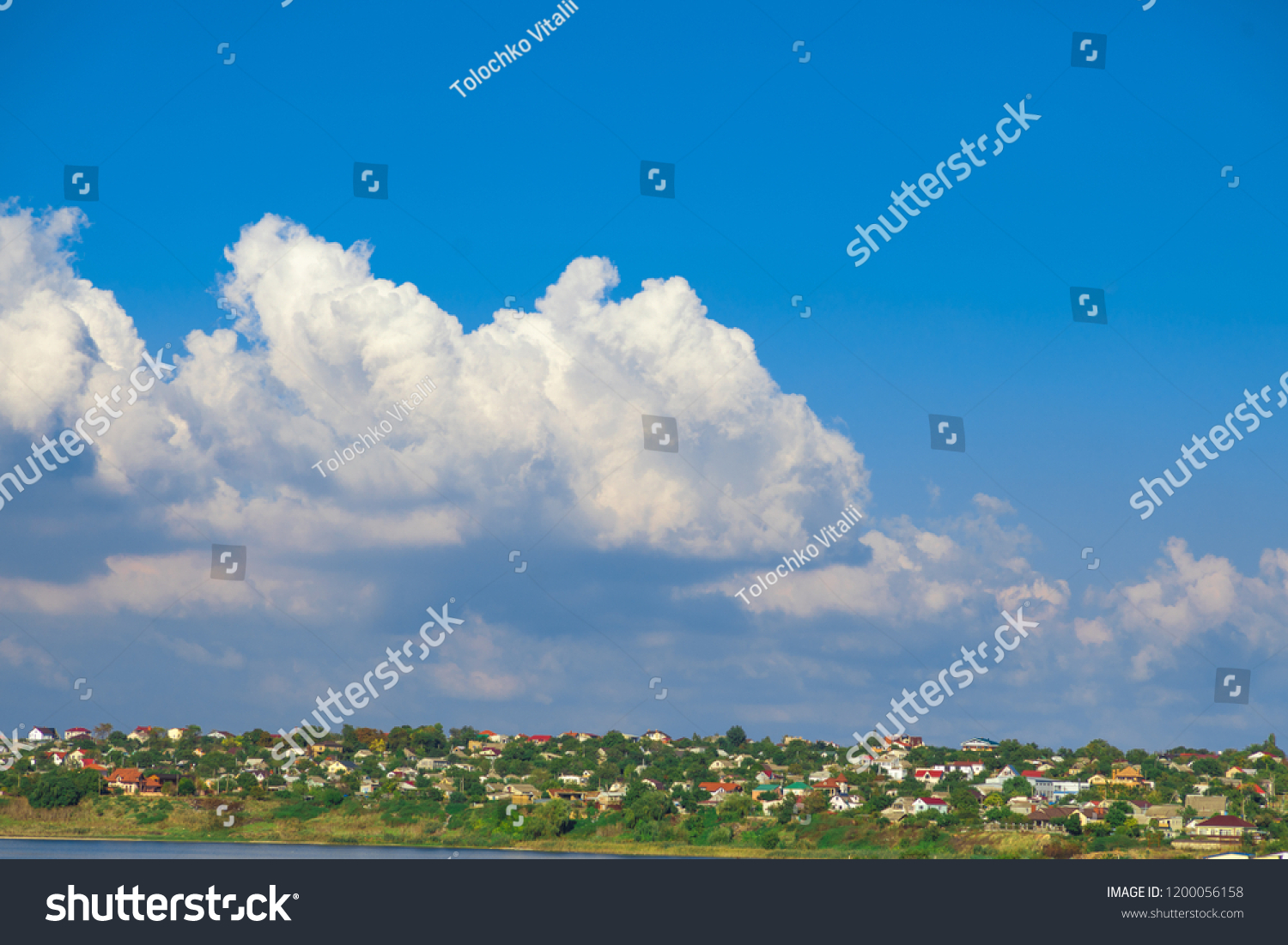 clouds in the blue sky over the village #1200056158