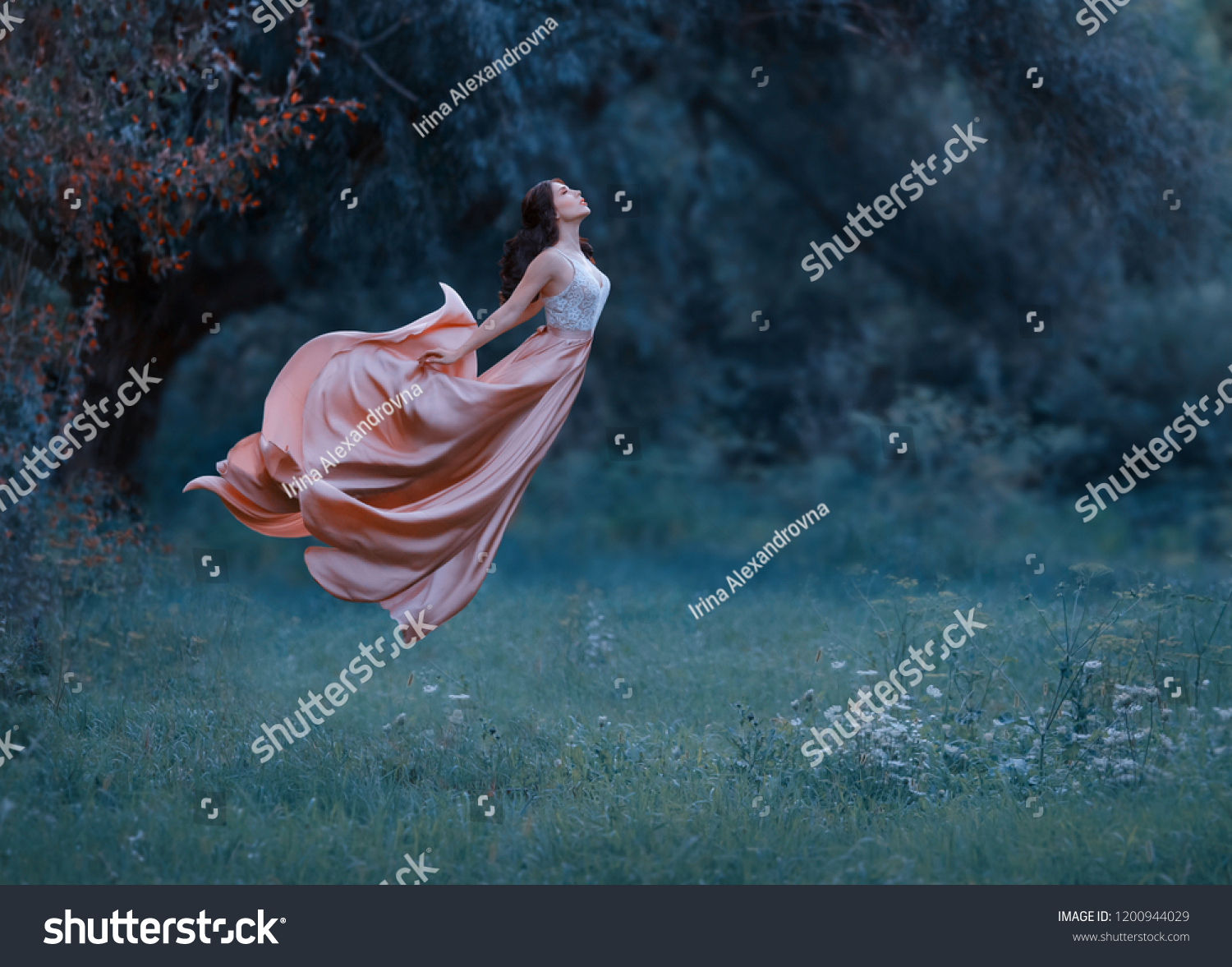 portrait young woman witch floating air spirit power spirituality ghost butterfly. luxury dress waving silk skirt fabric fly wind. Cold blue green grass forest. Enchanted princess Art photo levitation #1200944029