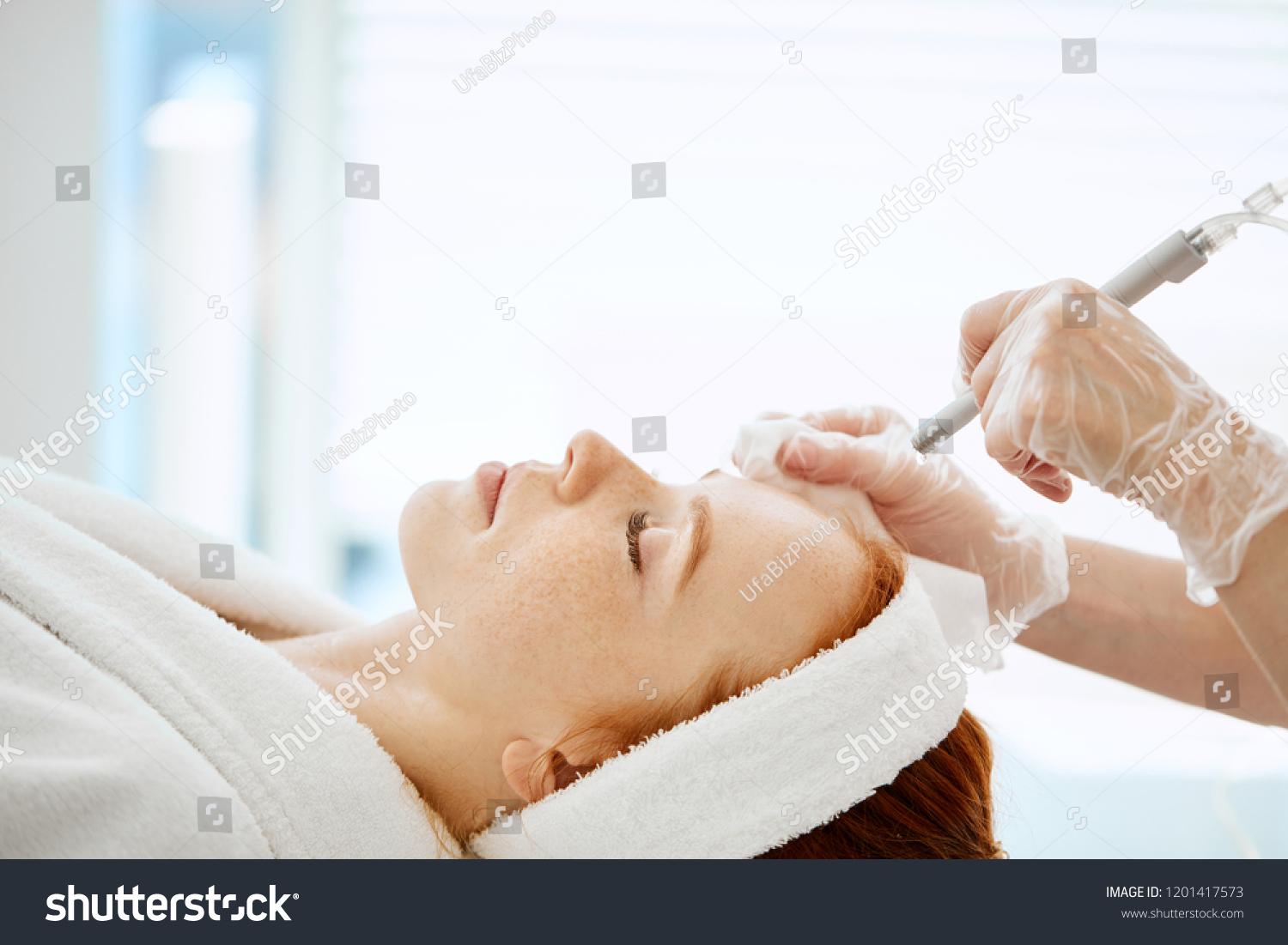 Caucasian woman getting face peeling procedure in a beauty clinic, close up. Rejuvenating facial gas liquid treatment. Hydro air skin cleansing operation. #1201417573