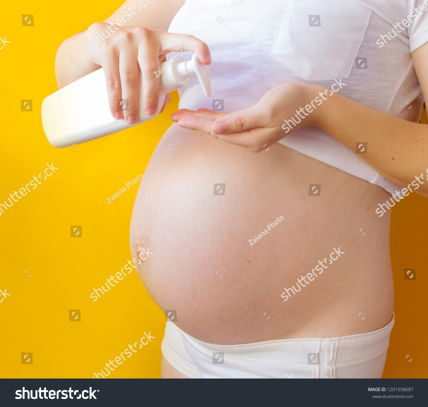 pregnant woman with cream from stretch marks #1201558687