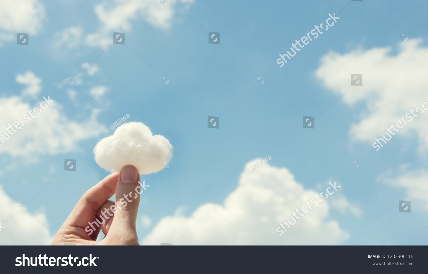 Woman hand holding cotton wool on cloud sky background. The development of the imagination, copy space. #1202906116