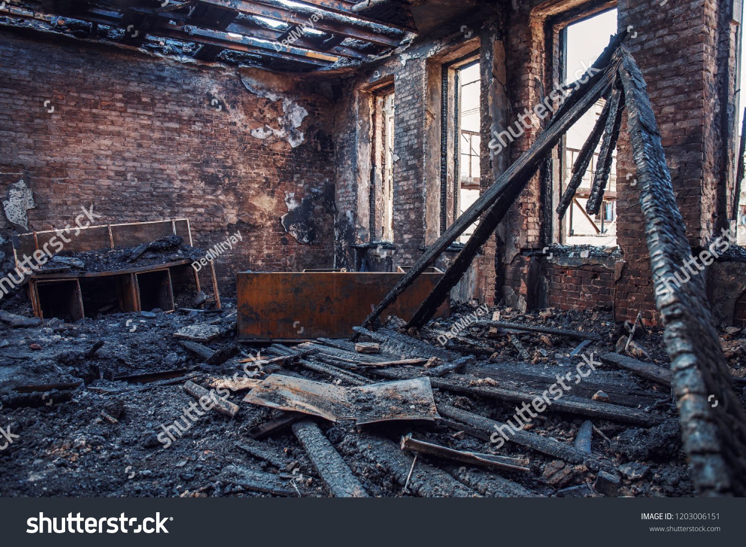 Burned house interior after fire, ruined building room inside, disaster or war aftermath concept #1203006151