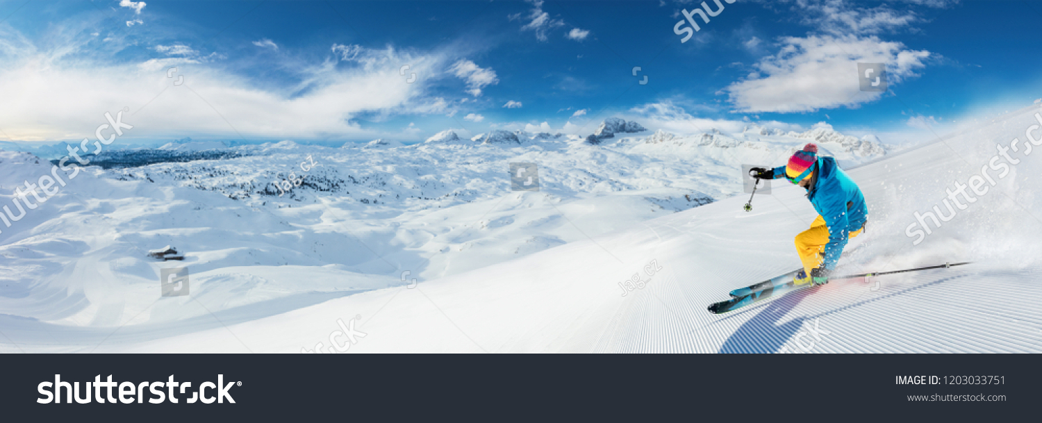 Alpine skier skiing downhill, panoramic format. Winter sports and leasure activities #1203033751