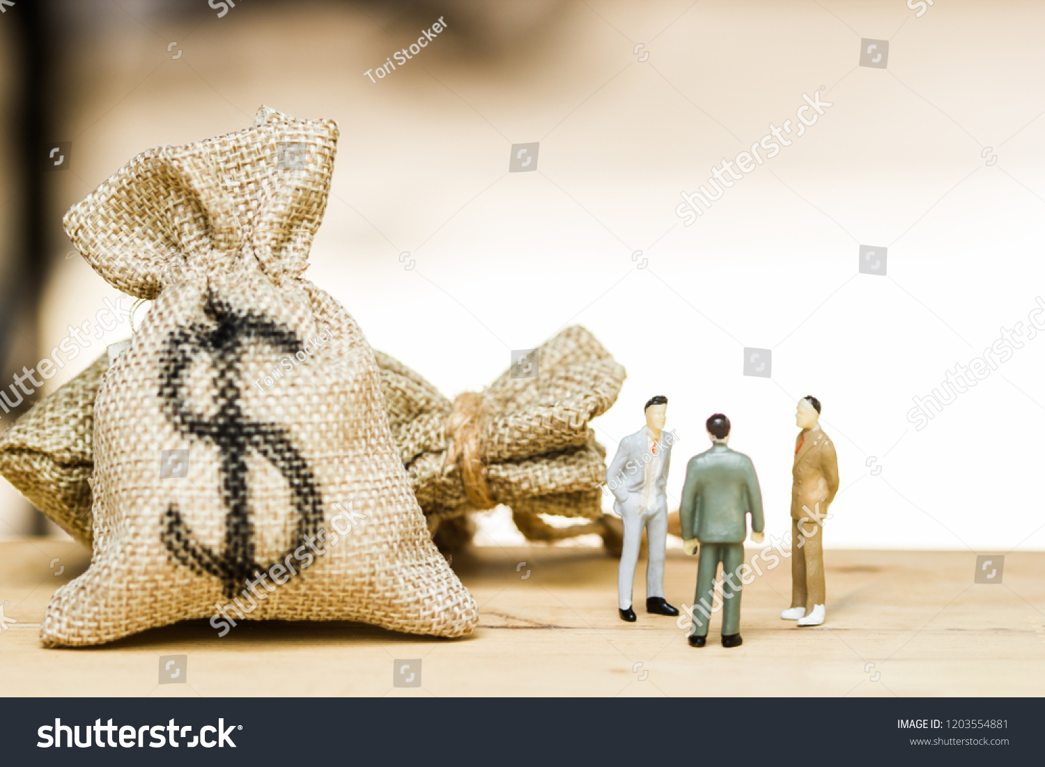 Financial investment negotiation,discussion among CEO or execute level concept: Miniature figurine three businessmen talk on money invest contract agreement, discuss about company direction in future. #1203554881