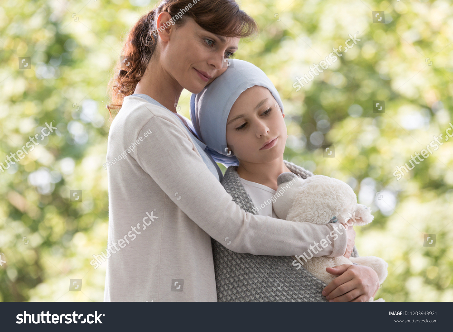 Mother hugging sad daughter with cancer #1203943921