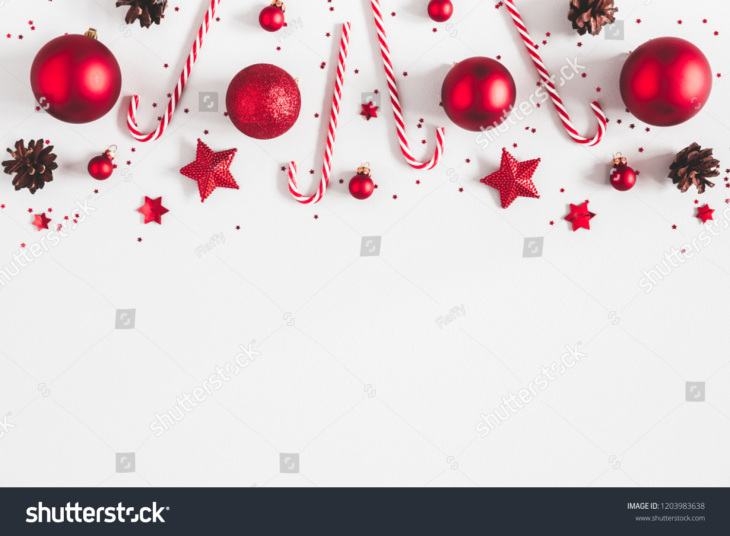 Christmas composition. Border made of red decorations on white background. Christmas, winter, new year concept. Flat lay, top view, copy space #1203983638