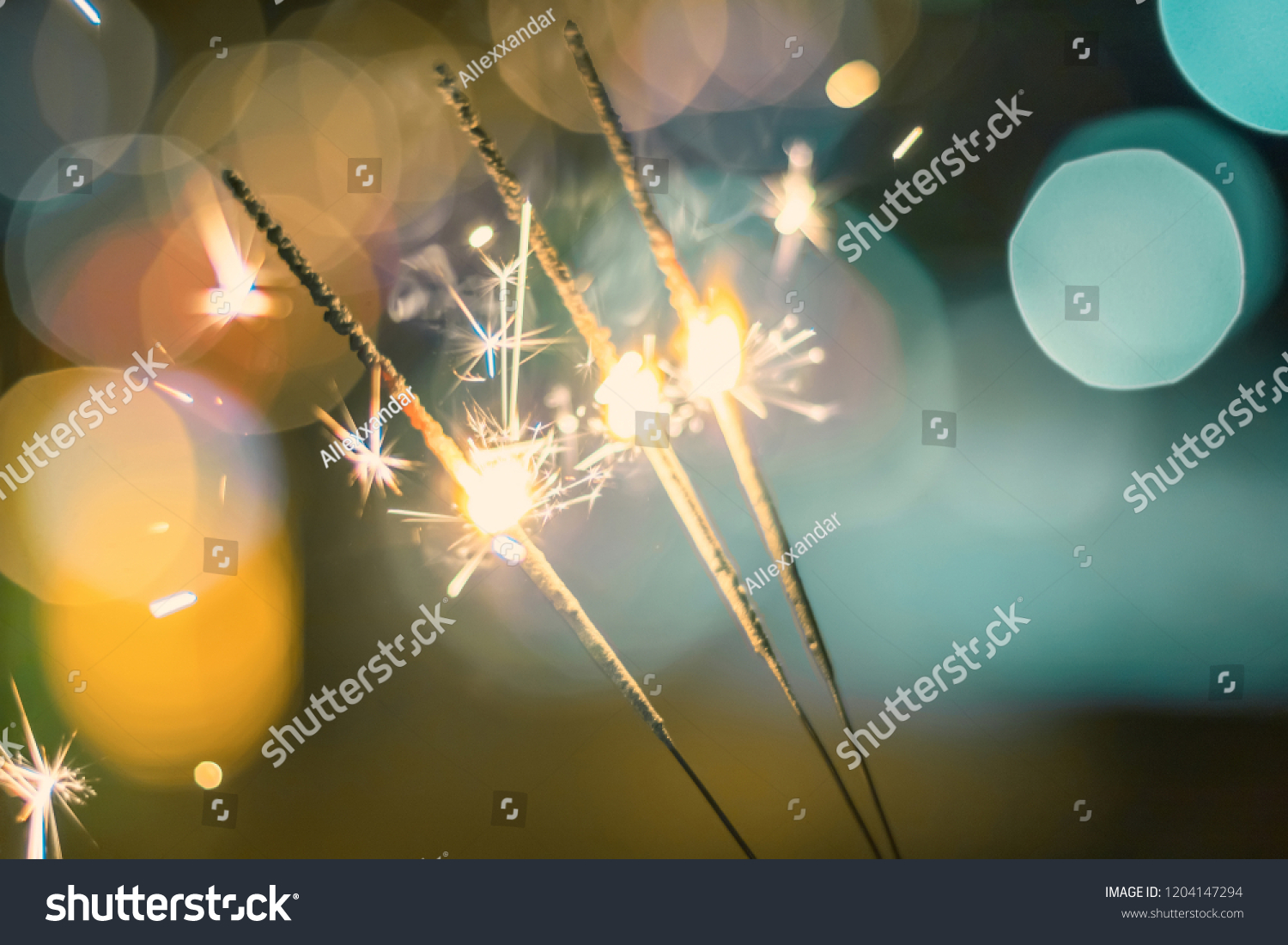 Sparkler Bokeh Colorful sparkler. Night background with a sparkler.  #1204147294