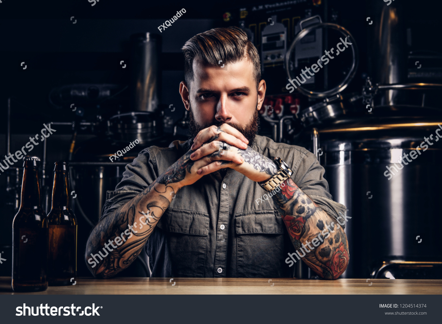 Portrait of a pensive tattooed hipster male with stylish beard and hair in the shirt in indie brewery.   #1204514374