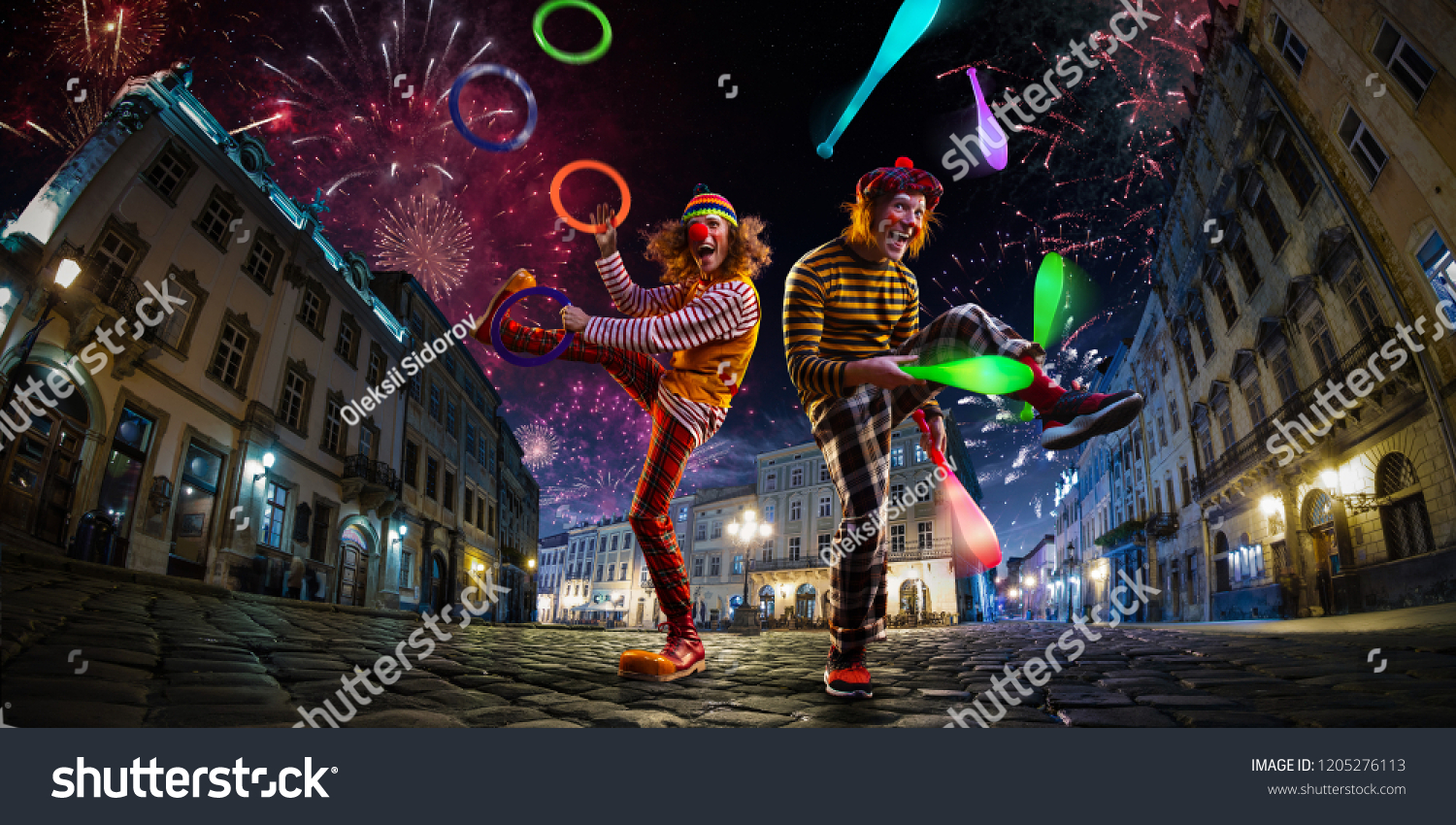 Night street circus performance whit two clowns, juggler. Festival city background. fireworks and Celebration atmosphere. #1205276113