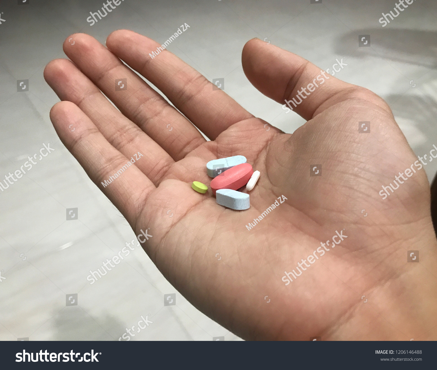 Colorful pills and medicines in the hand. Healthcare and medical concept. Image contains noise texture #1206146488