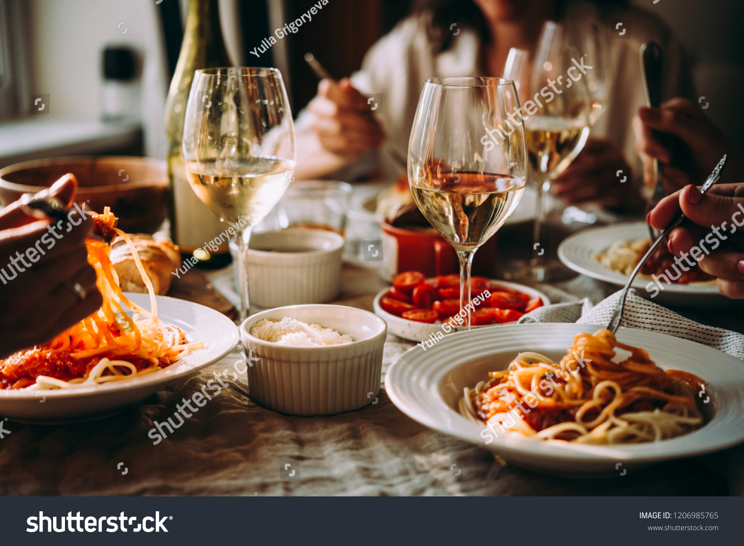 Friends having a pasta dinner at home of at a restaurant. #1206985765