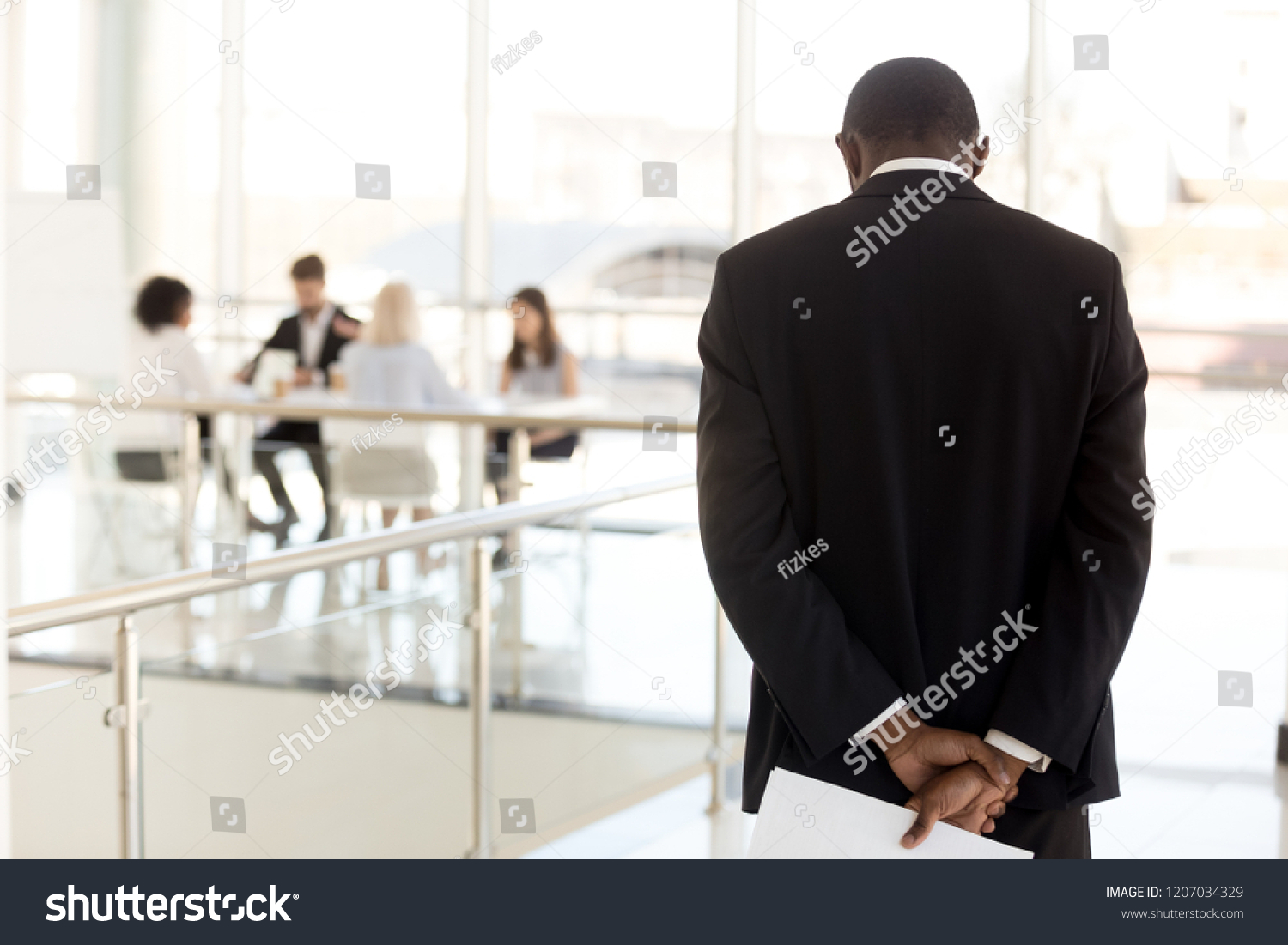 Nervous African American employee standing in hallway waiting to enter business meeting, worried black presenter anxious about making presentation for colleagues or workers in boardroom #1207034329