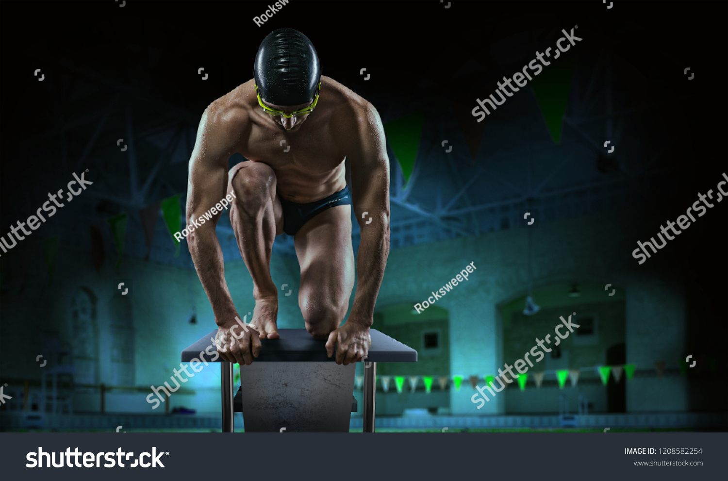 Swimming pool. Muscular swimmer ready to jump. #1208582254