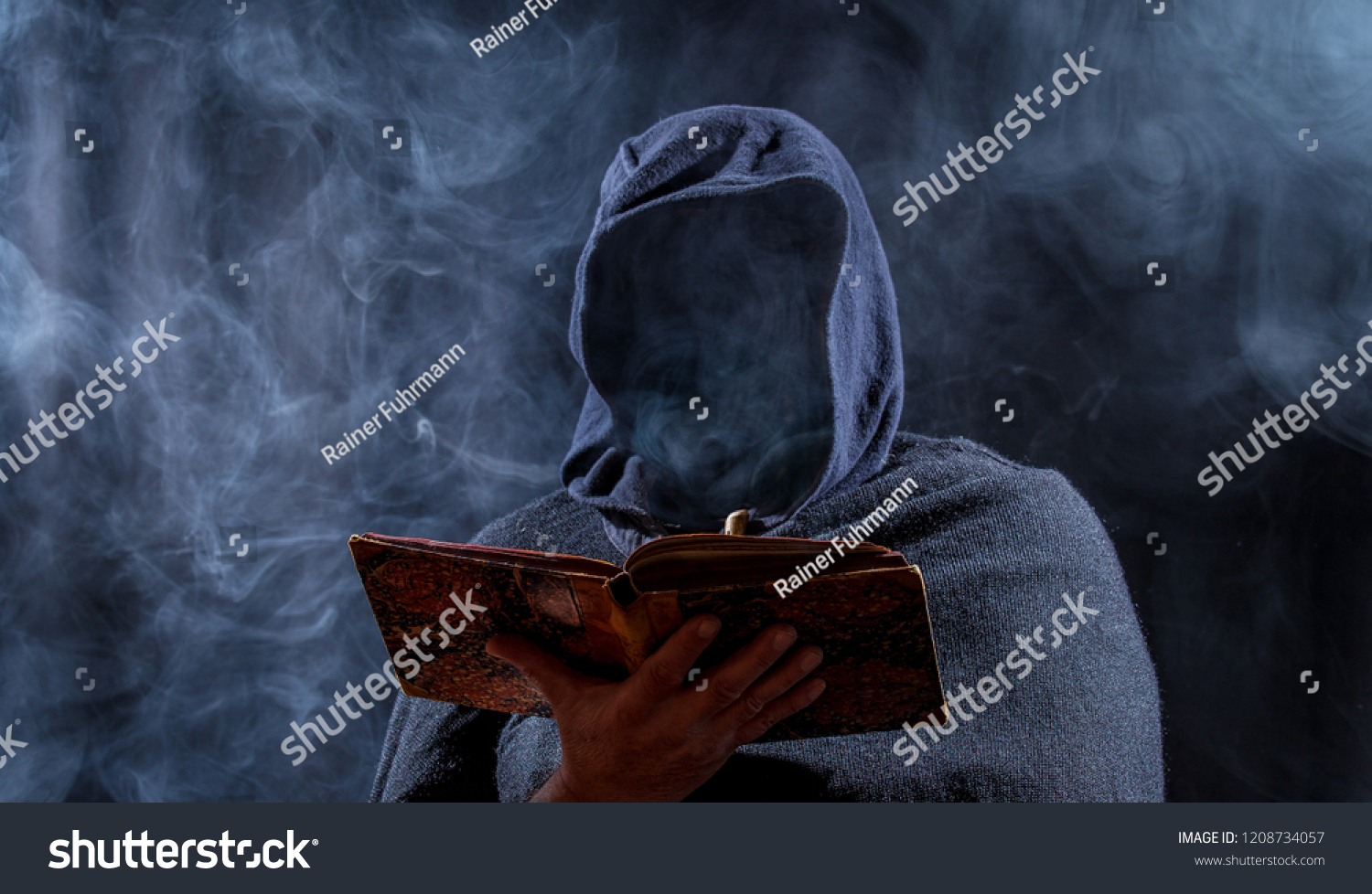 a man hides his face and reads in a book #1208734057