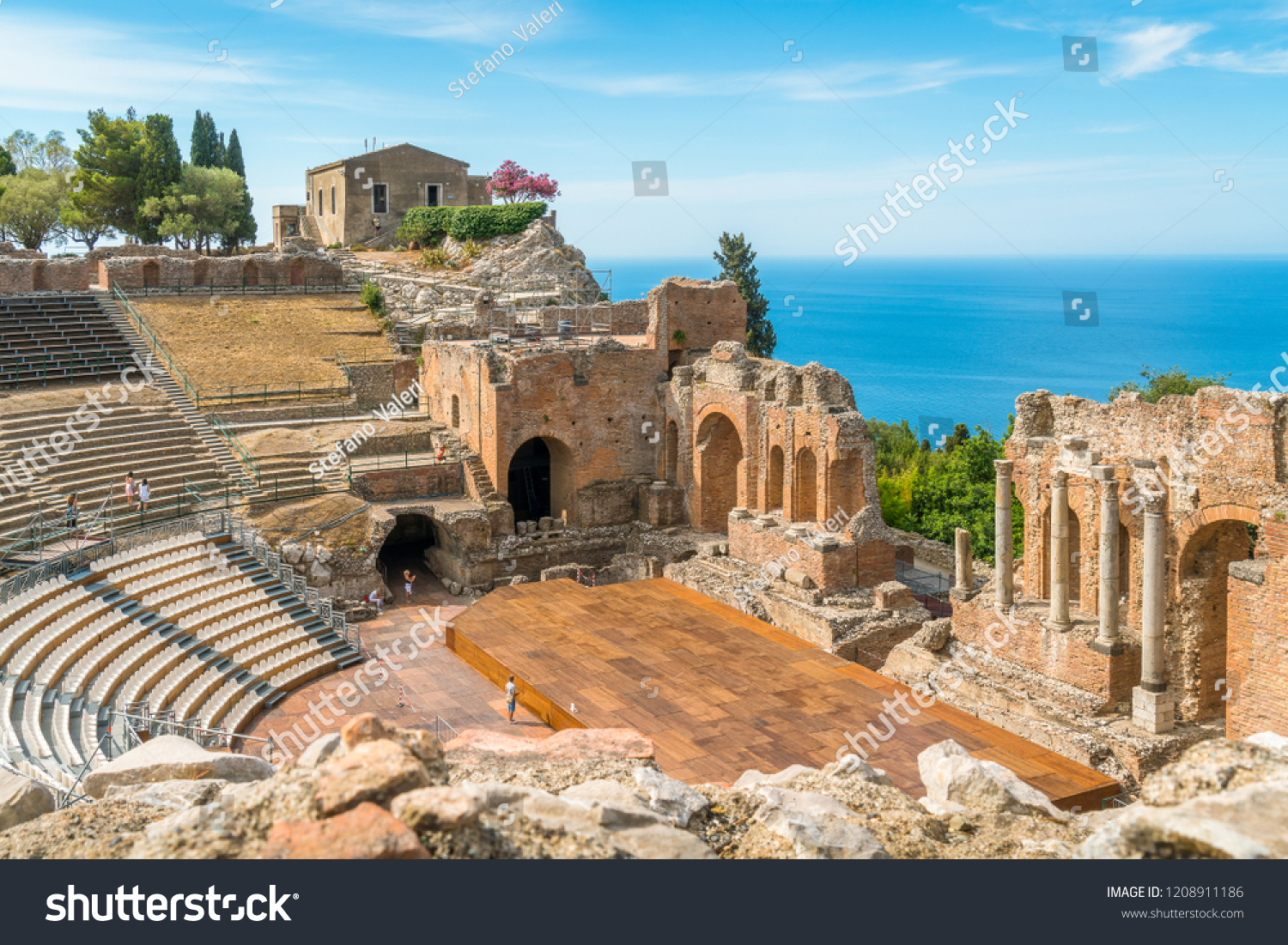 Ruins of the Ancient Greek Theater in Taormina on a sunny summer day with the mediterranean sea. Province of Messina, Sicily, southern Italy. #1208911186