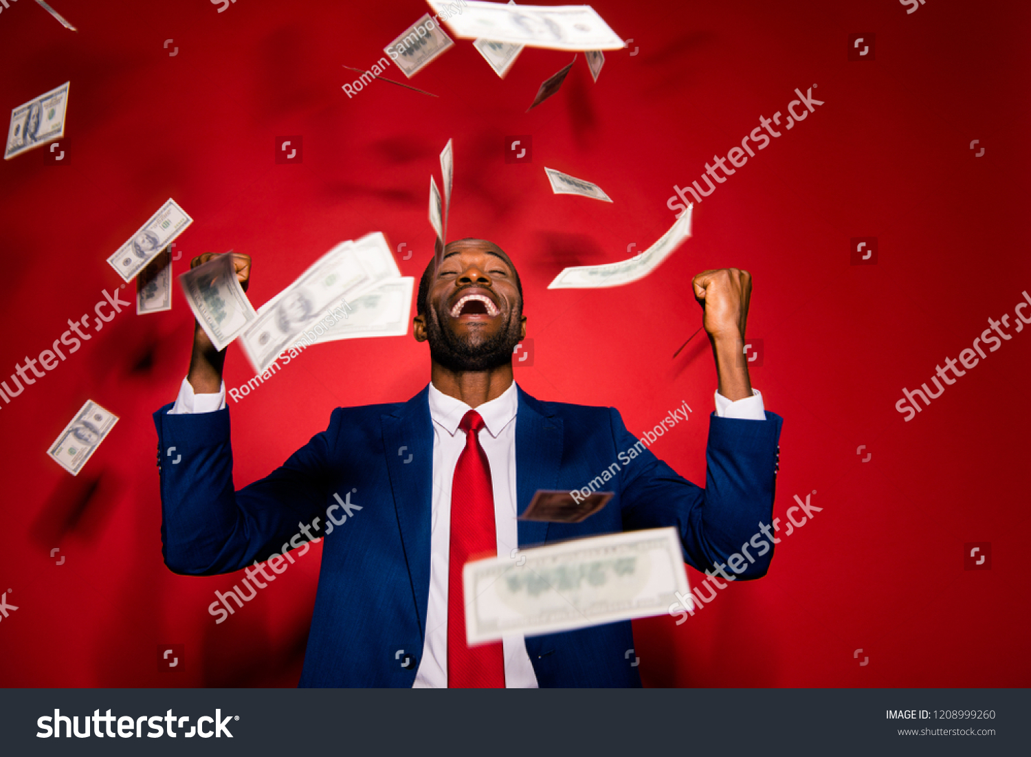 Emotion reaction concept. Crazy man in stylish trendy style formal wear tux tuxedo jacket suit tie close eyes raised fists up isolated on red bright background under money rain #1208999260
