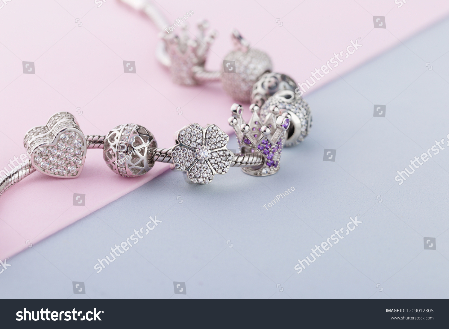 Bracelet with silver charm beads with gems. Flower, crown, ball, heart beads.  Product concept for jeweler #1209012808
