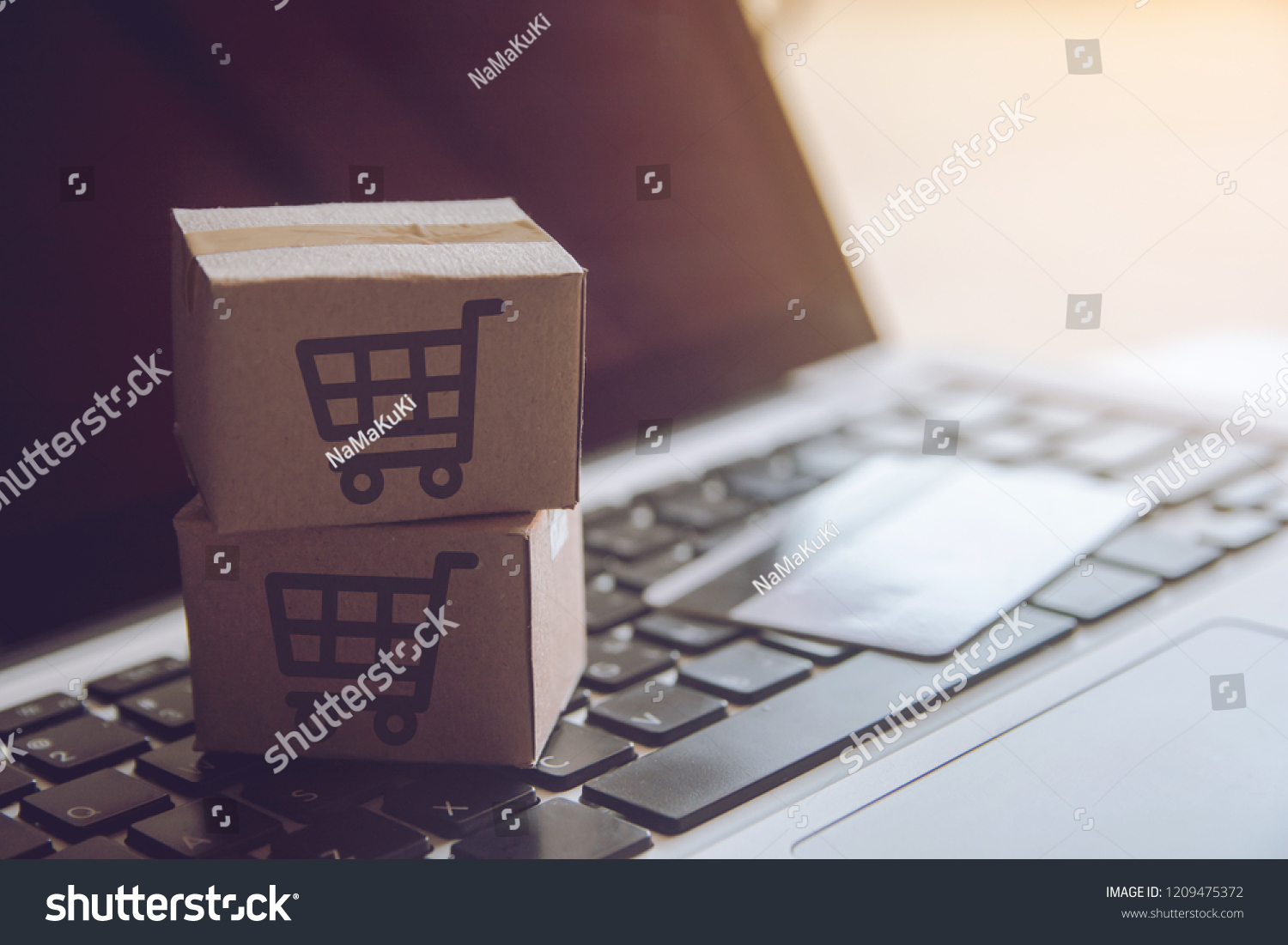 Shopping online concept - Shopping service on The online web. with payment by credit card and offers home delivery. parcel or Paper cartons with a shopping cart logo on a laptop keyboard
 #1209475372