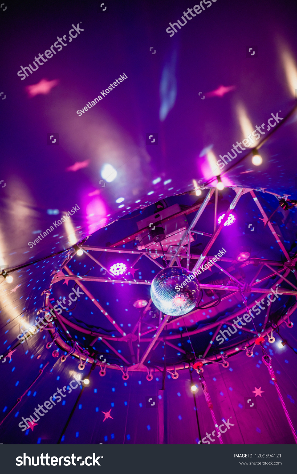 Disco ball under the dome of the circus. Circus illumination. #1209594121