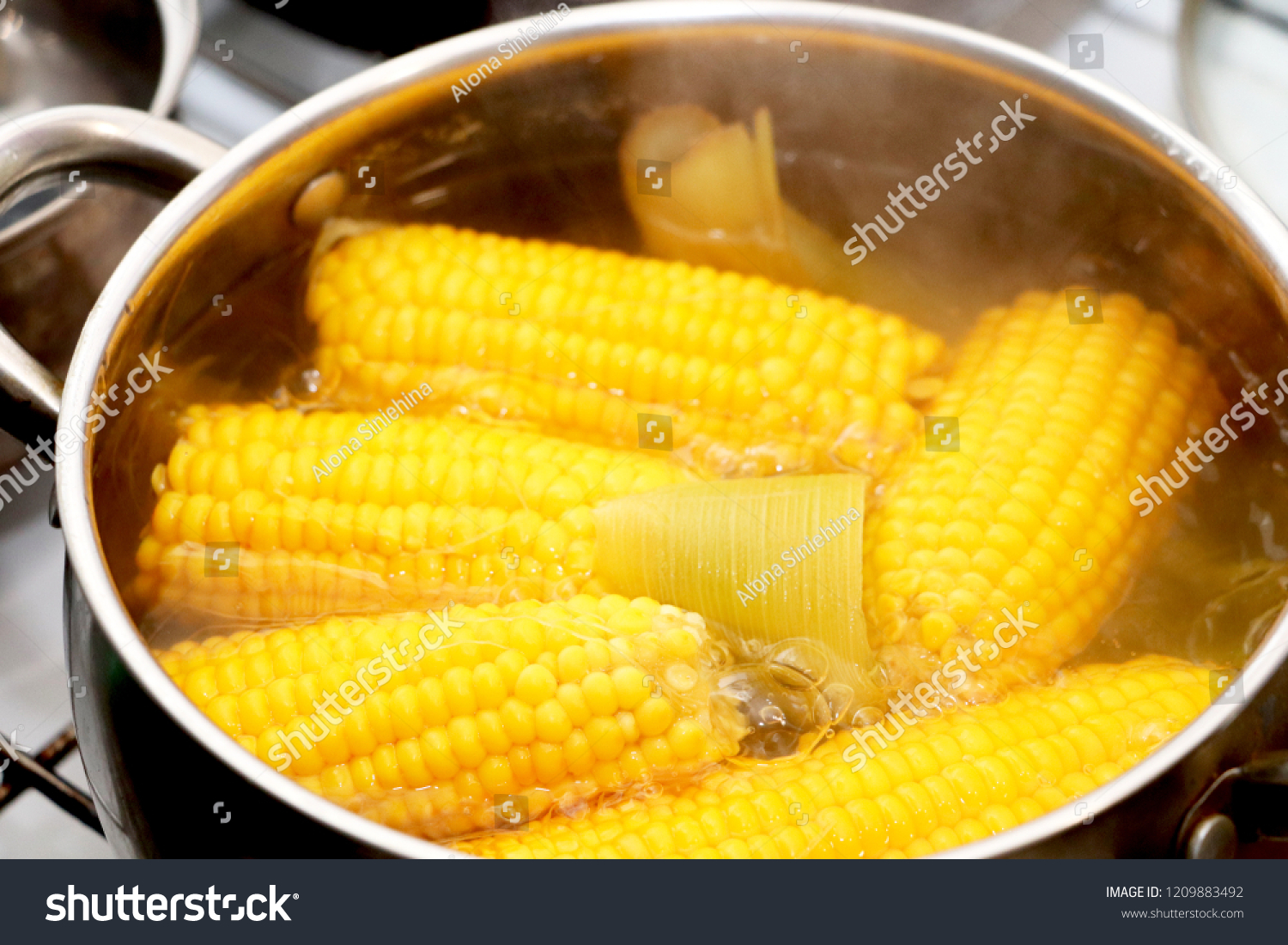 Yellow corn stew in a saucepan. Flavored dinner #1209883492