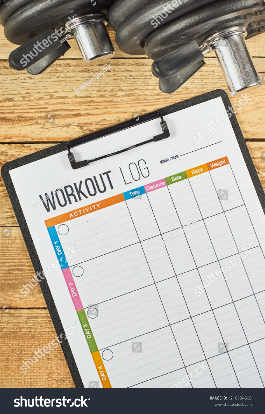 Healthy lifestyle concept. Mock up on workout and fitness dieting diary. Workout log sheet and dumbbells on a wooden background. #1210134508
