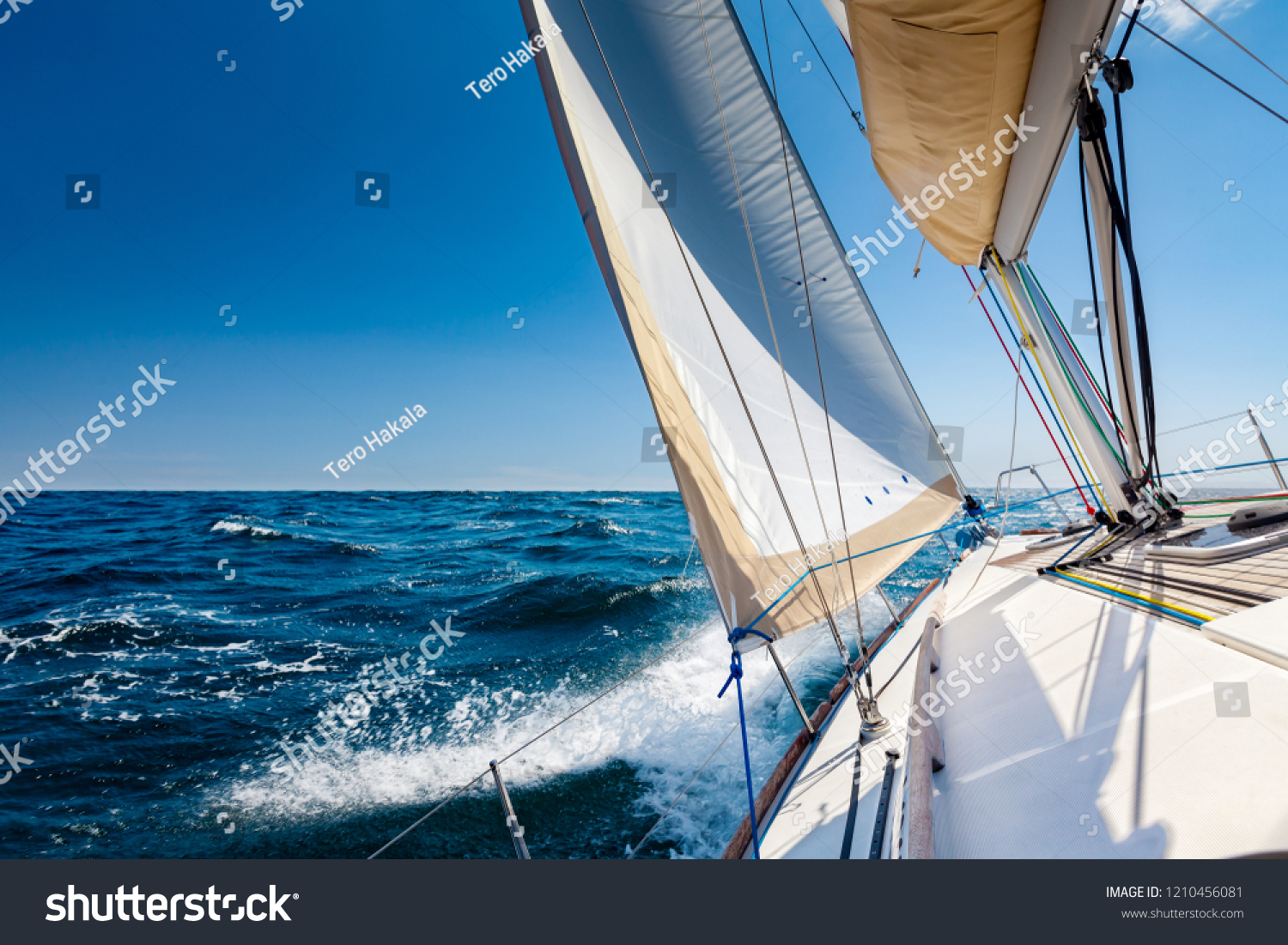 White sailing boat at open sea in sunshine #1210456081