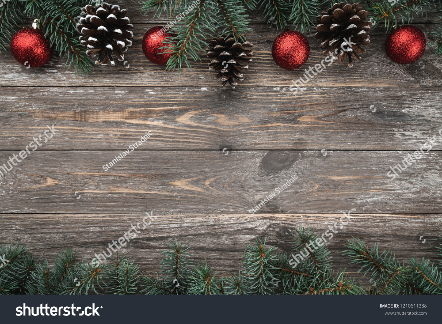Old wood background with fir branches adorned with baubles and cones. Space for text. Christmas card. Top view. Xmas. #1210611388
