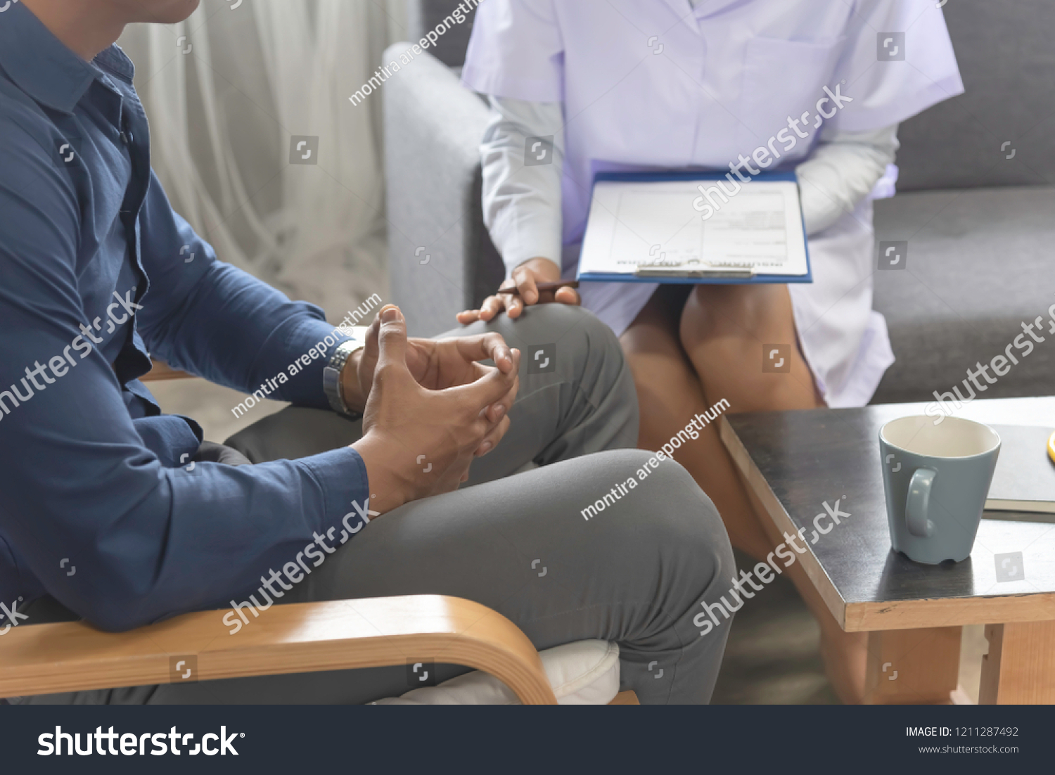 Asian woman doctor,gynecologist,psychiatrist consult and listen problem male patient at relax room in hospital. #1211287492