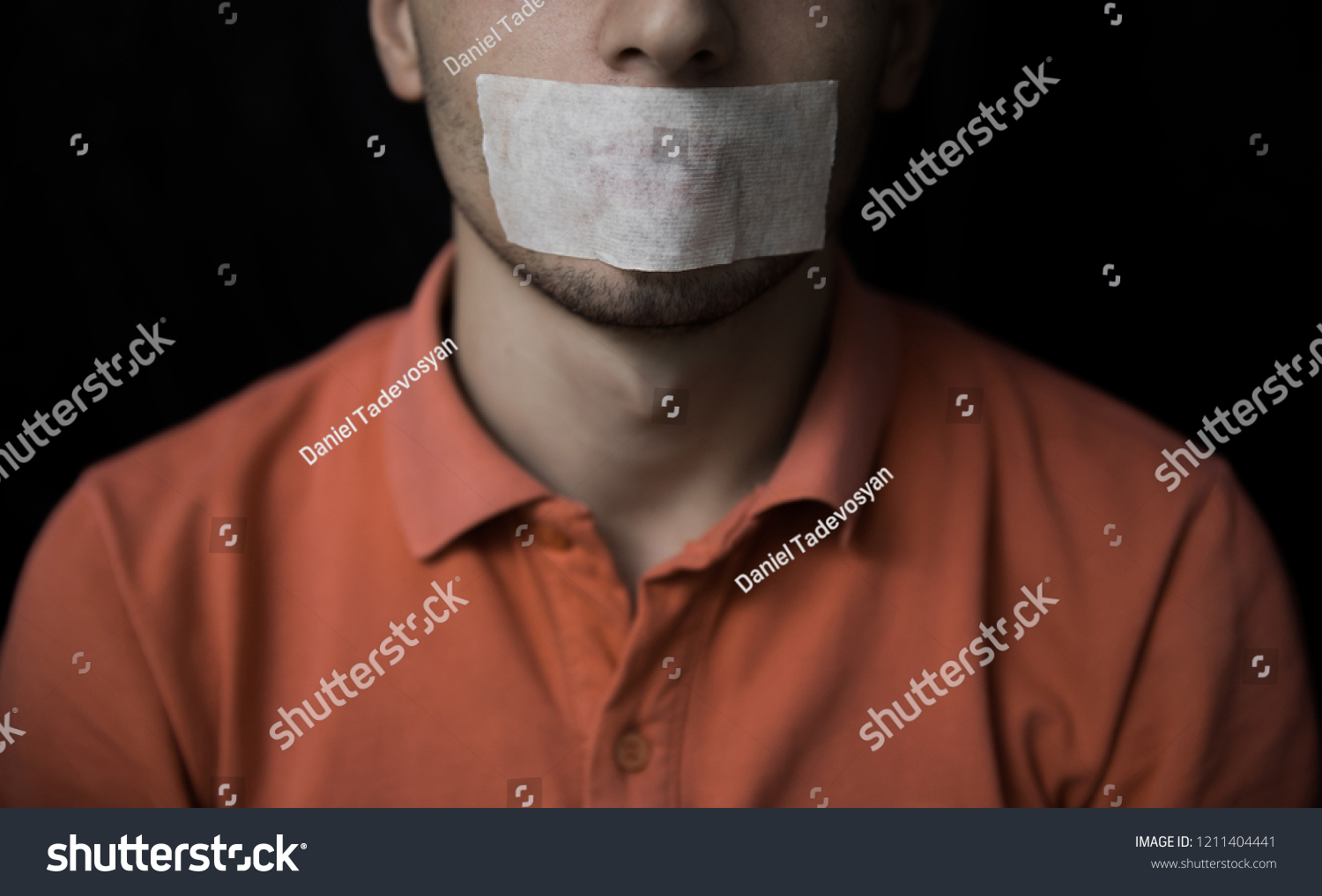 Man is silenced with adhesive tape on his mouth. #1211404441