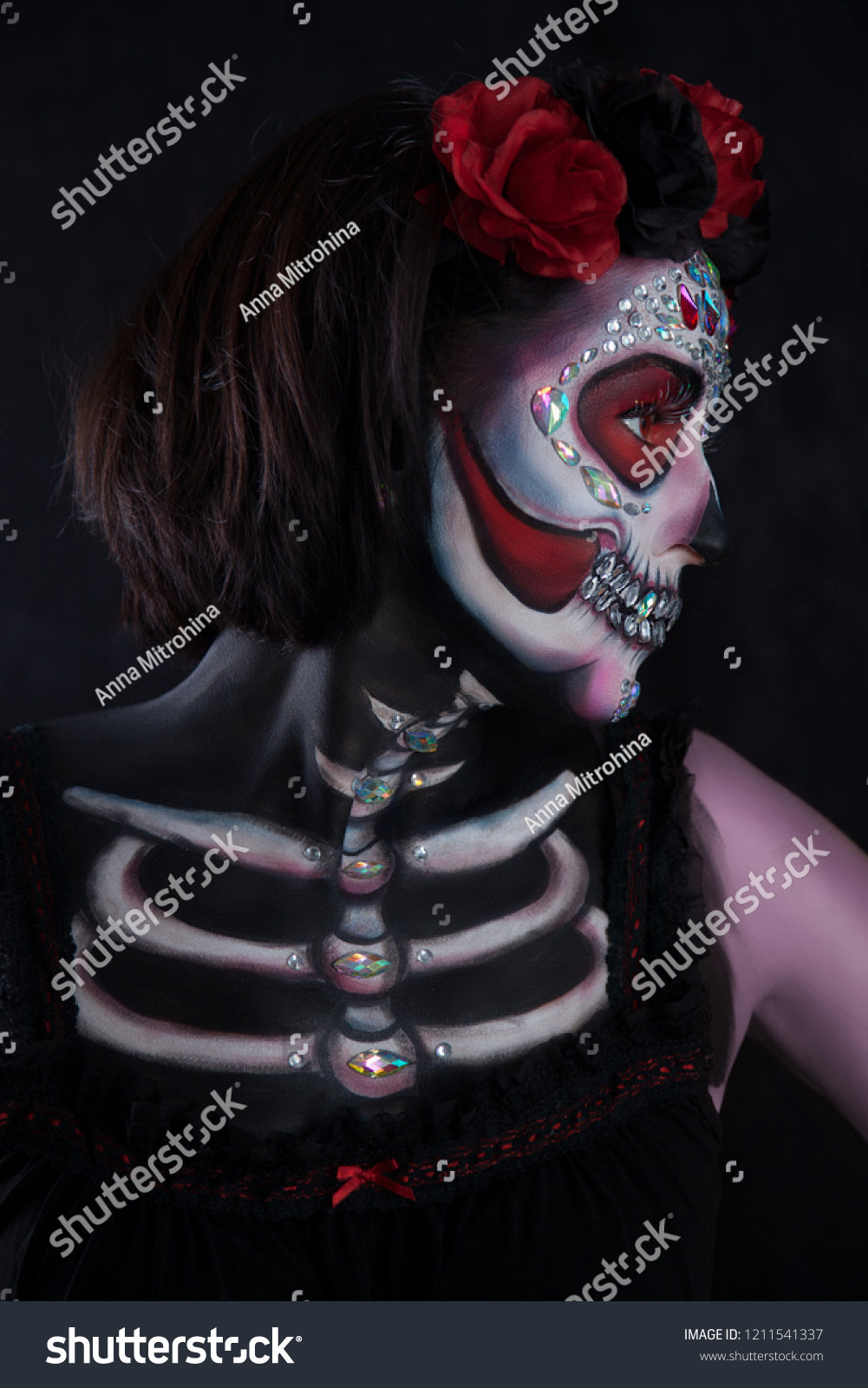 Beautiful women with skeleton face painting on black background.  Day of the Dead #1211541337