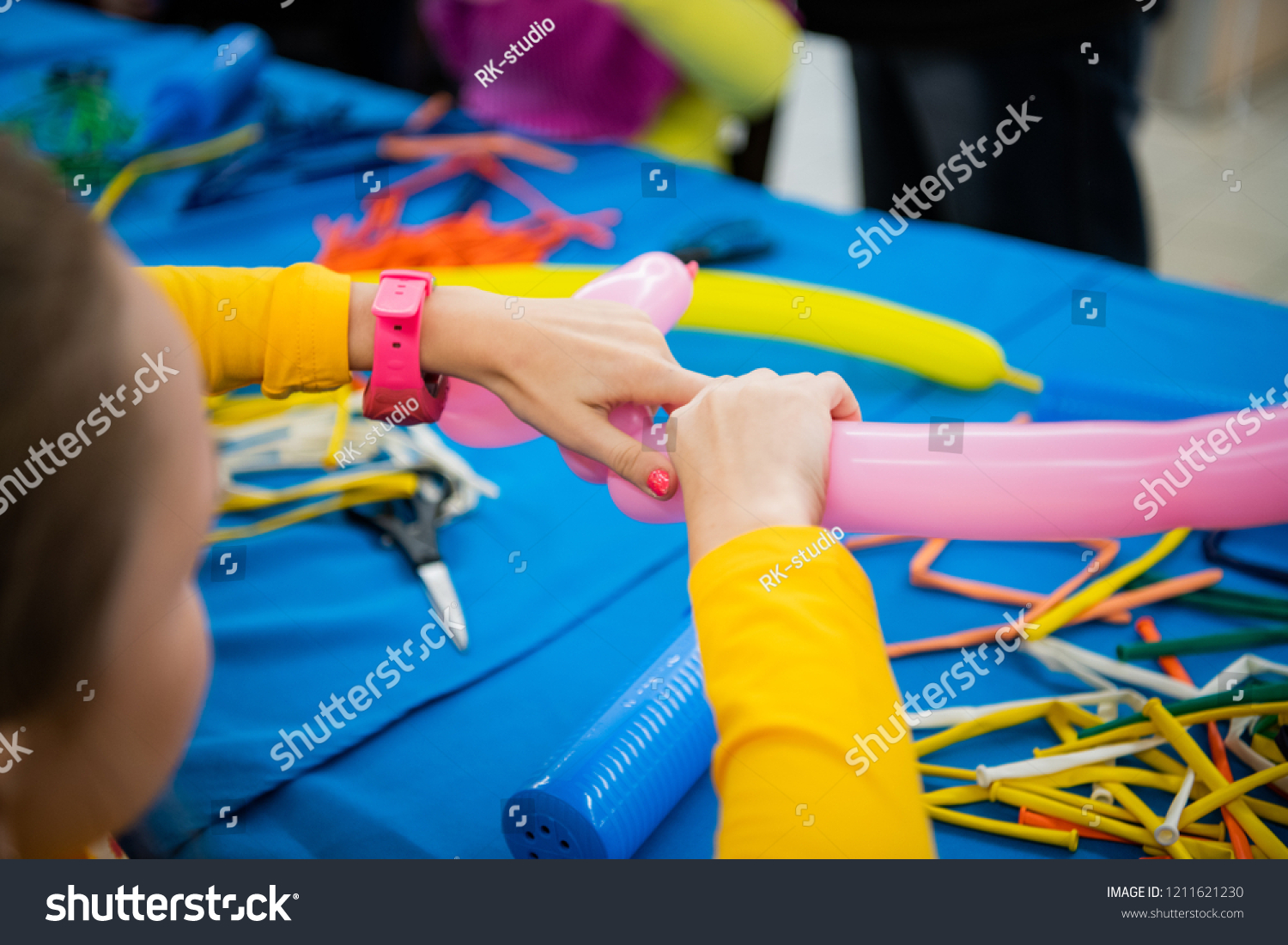 Happy children girl's hands with balloon on twisting art workshop #1211621230