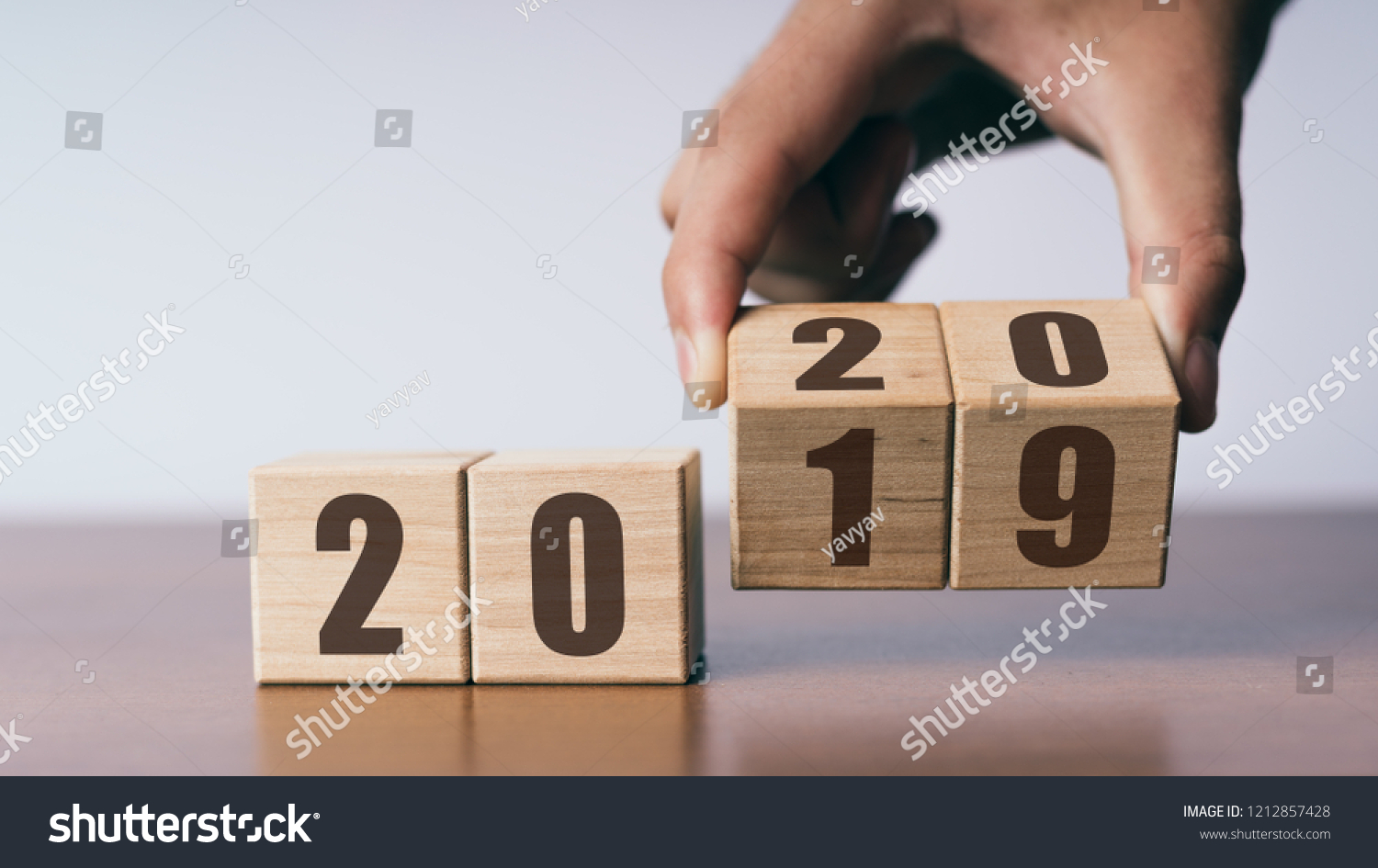 New year 2019 change to 2020 concept, hand change wooden cubes #1212857428