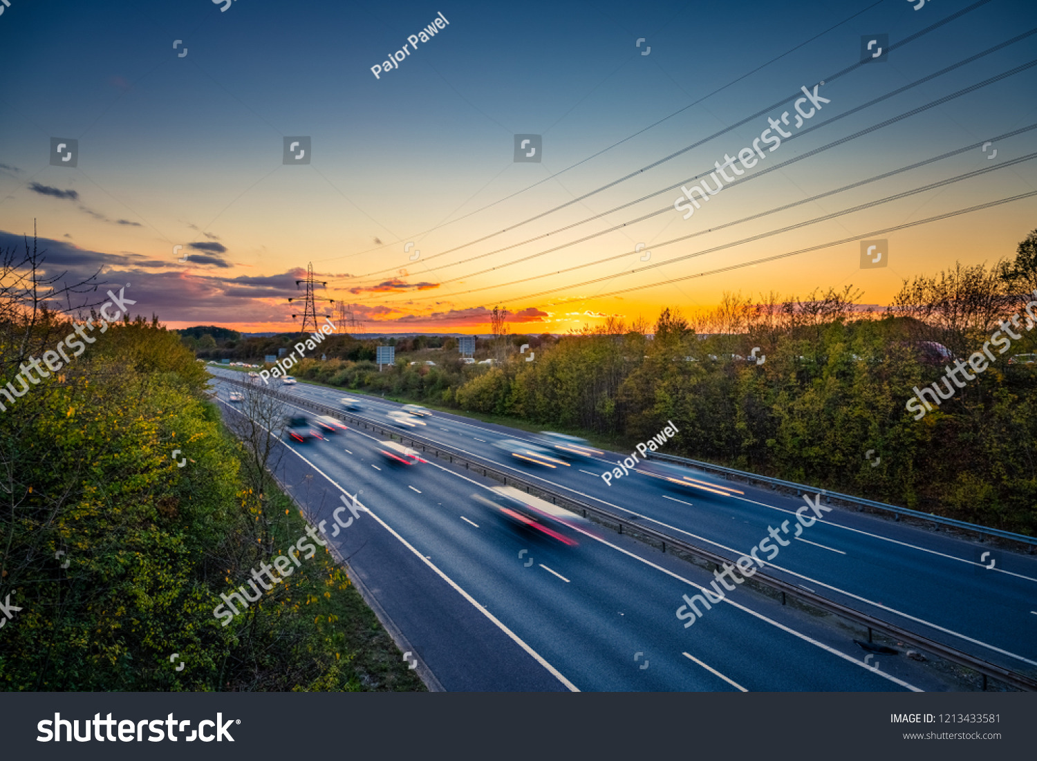 Motorway with blurry cars at sunset #1213433581