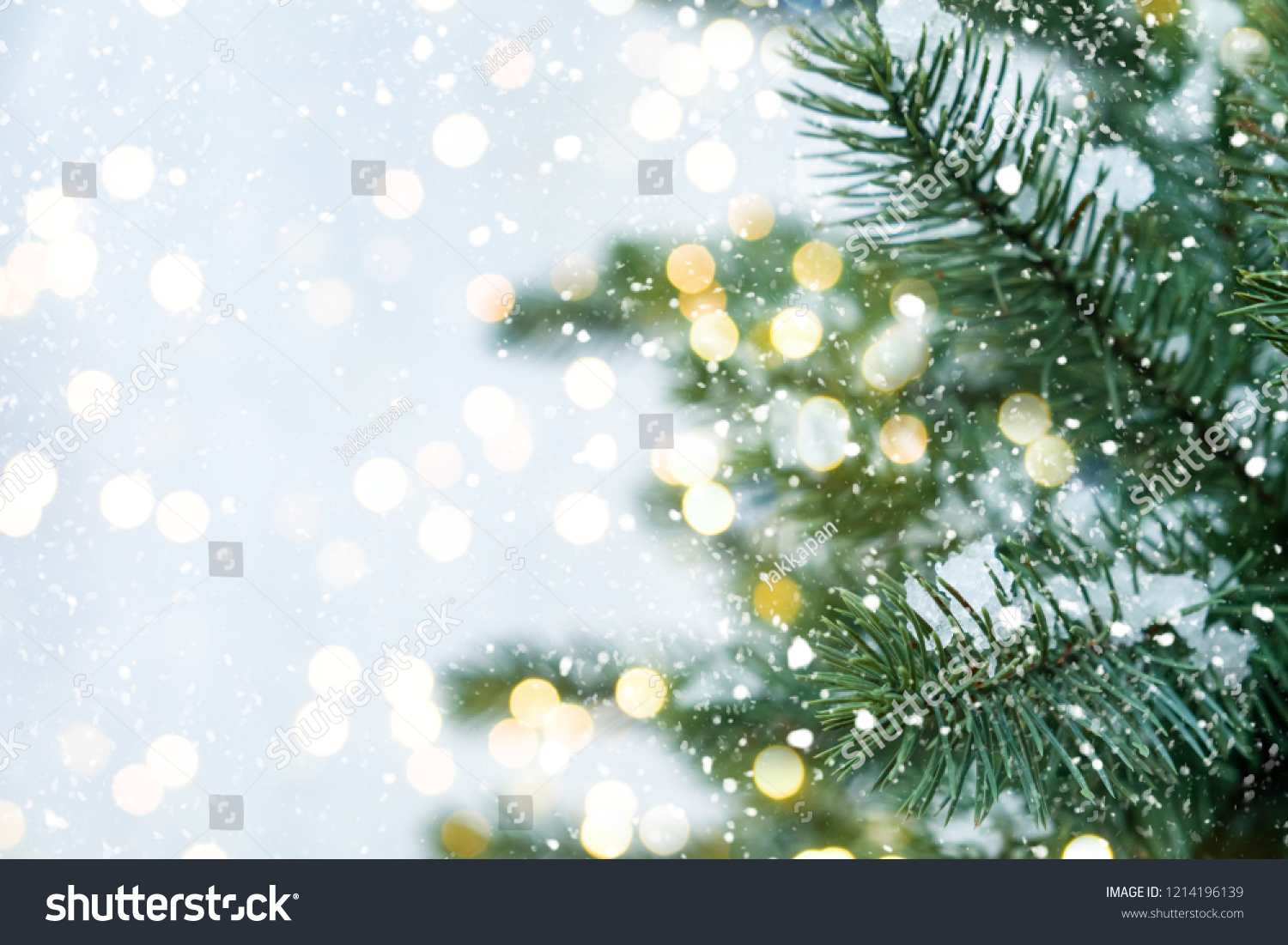 Closeup of Christmas tree with light, snow flake. Christmas and New Year holiday background. vintage color tone. #1214196139