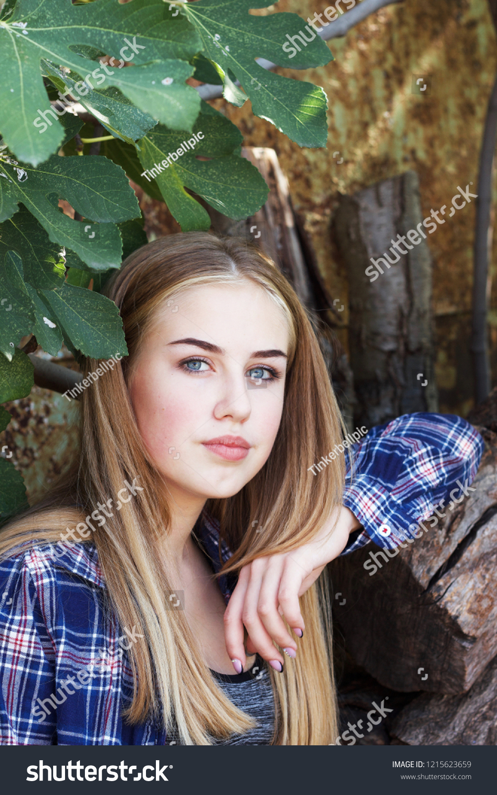 A divine, blue-eyed, blonde-haired, teenage girl in a checkered shirt  #1215623659