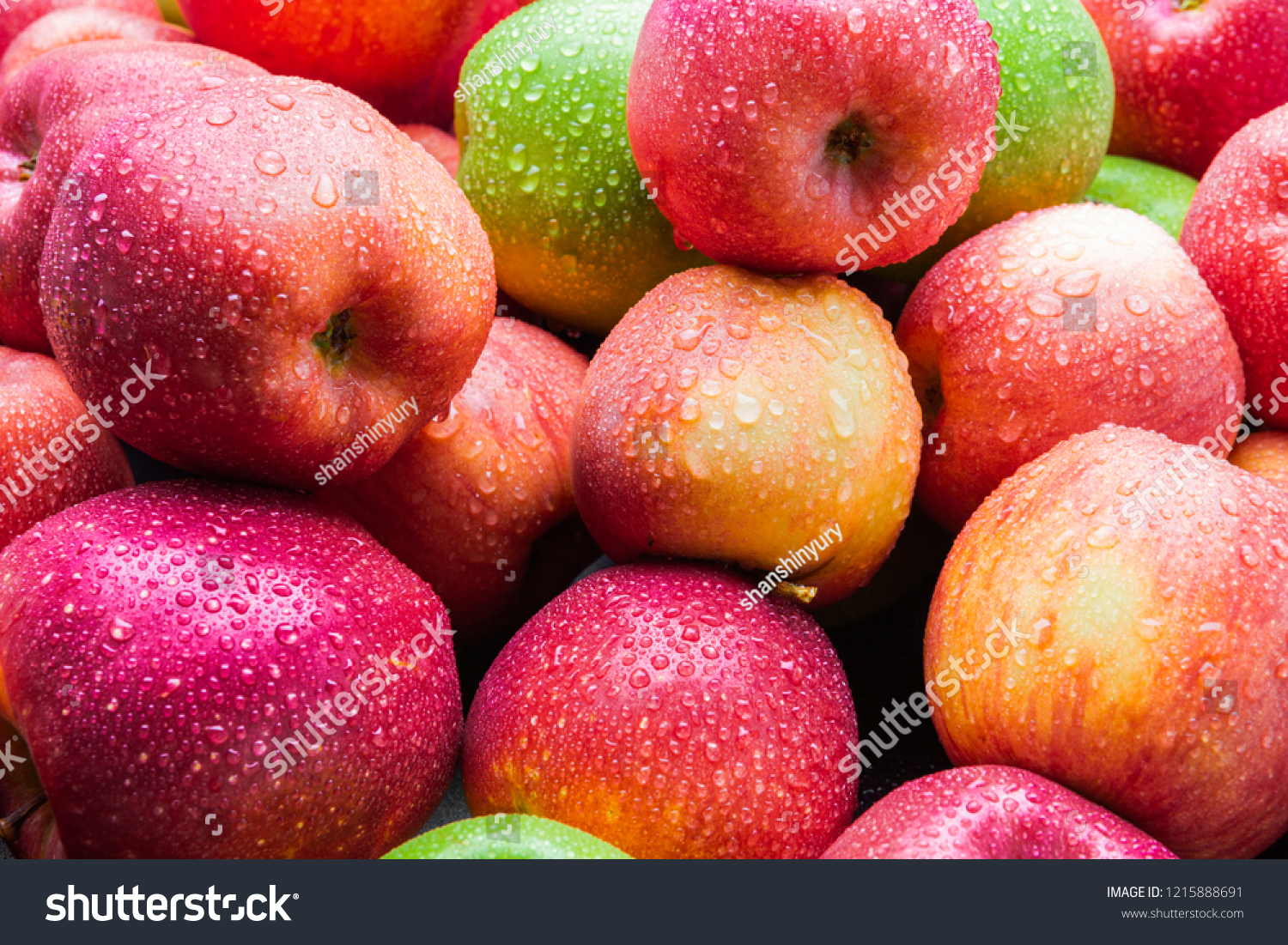 heap of fresh clean green and red apples with drops of water mix on black background, top side view closeup #1215888691