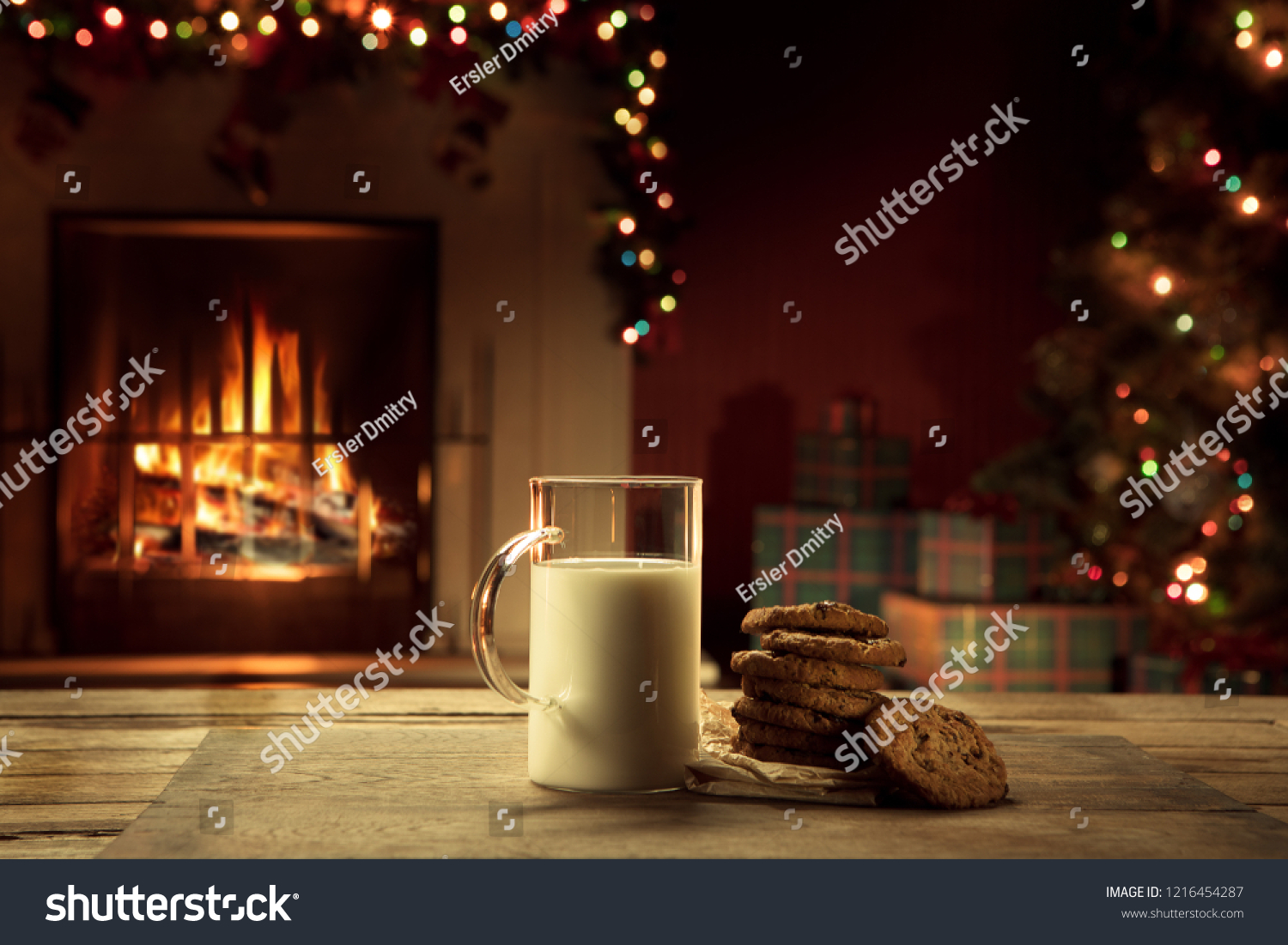 close up view of glass of milk with cookies on color back #1216454287