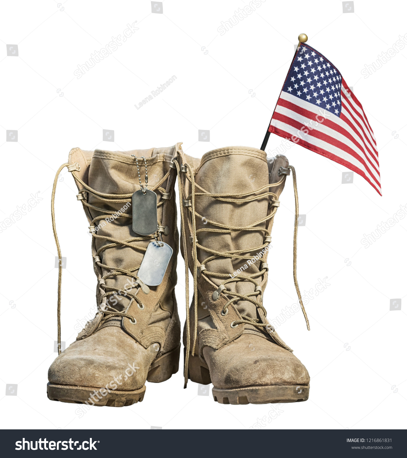 Old military combat boots with the American flag and dog tags, isolated on white background. Memorial Day or Veterans day concept. #1216861831