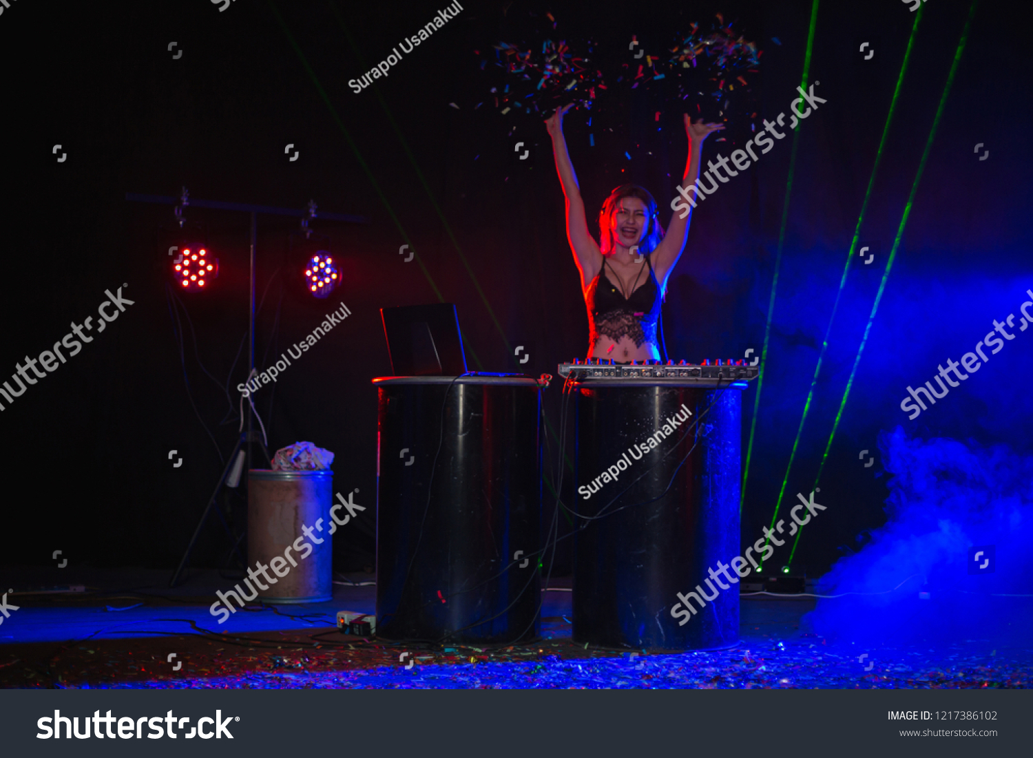 DJ Party Playing Mixing and Mastering Electronic Dance Music with electro light effects and lights #1217386102