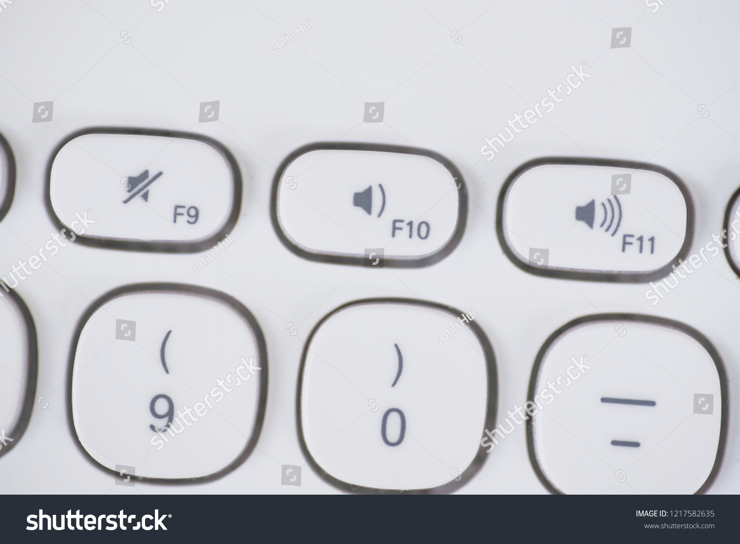 Close-up of Volume Shortcut keys of a white keyboard. Mute, volume down and volume up. #1217582635