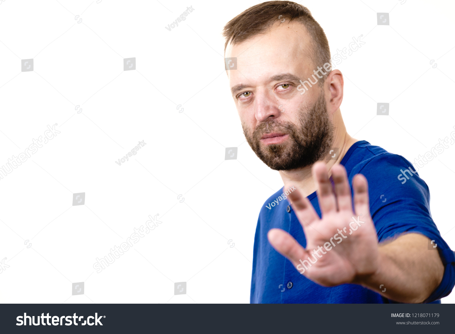 Serious man gesturing with palm hand showing stop refusing gesture. Human gesutres and expressions concept. #1218071179